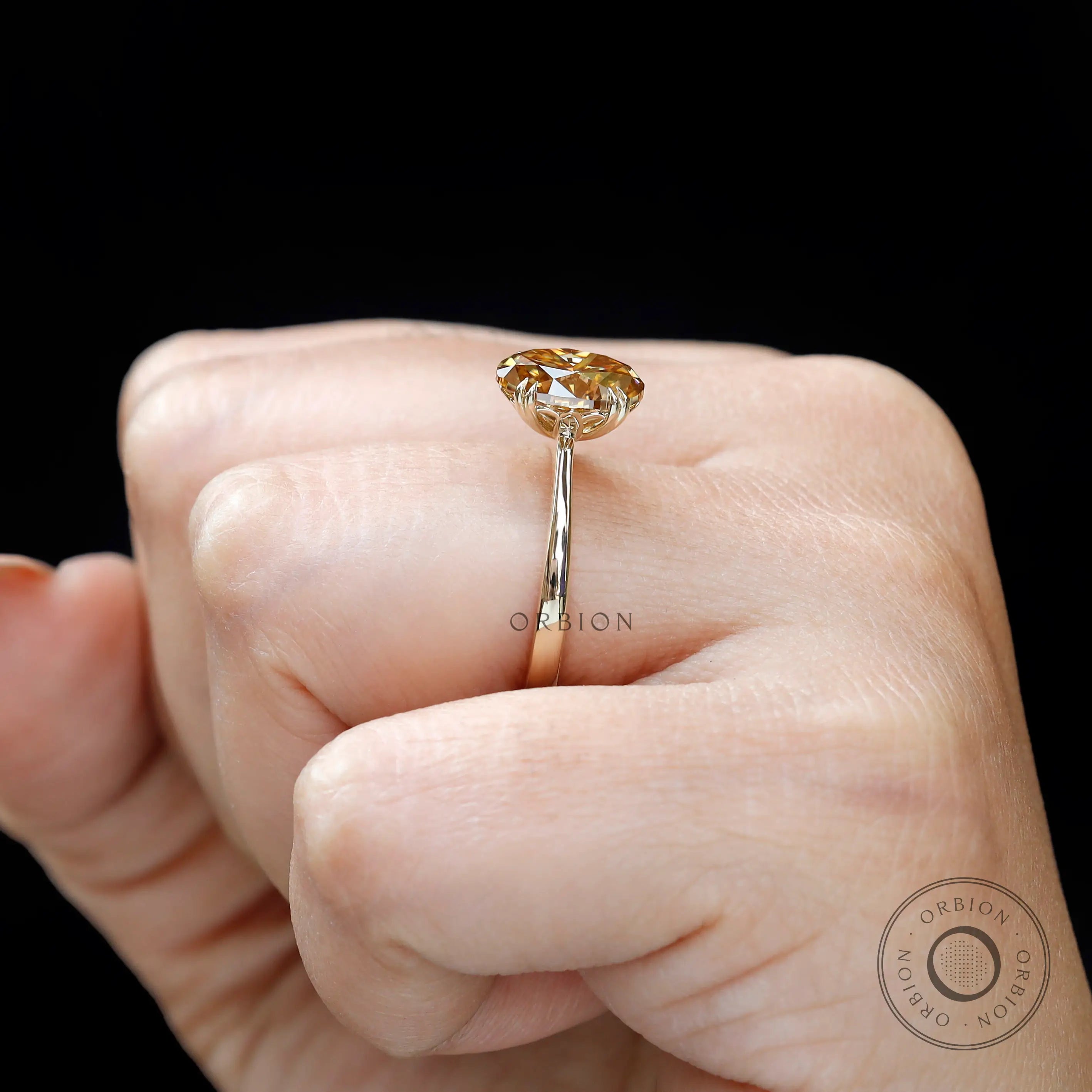 Dark champagne moissanite engagement ring on hand