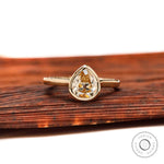 Pear Old Mine Cut light champagne moissanite bezel solitaire ring