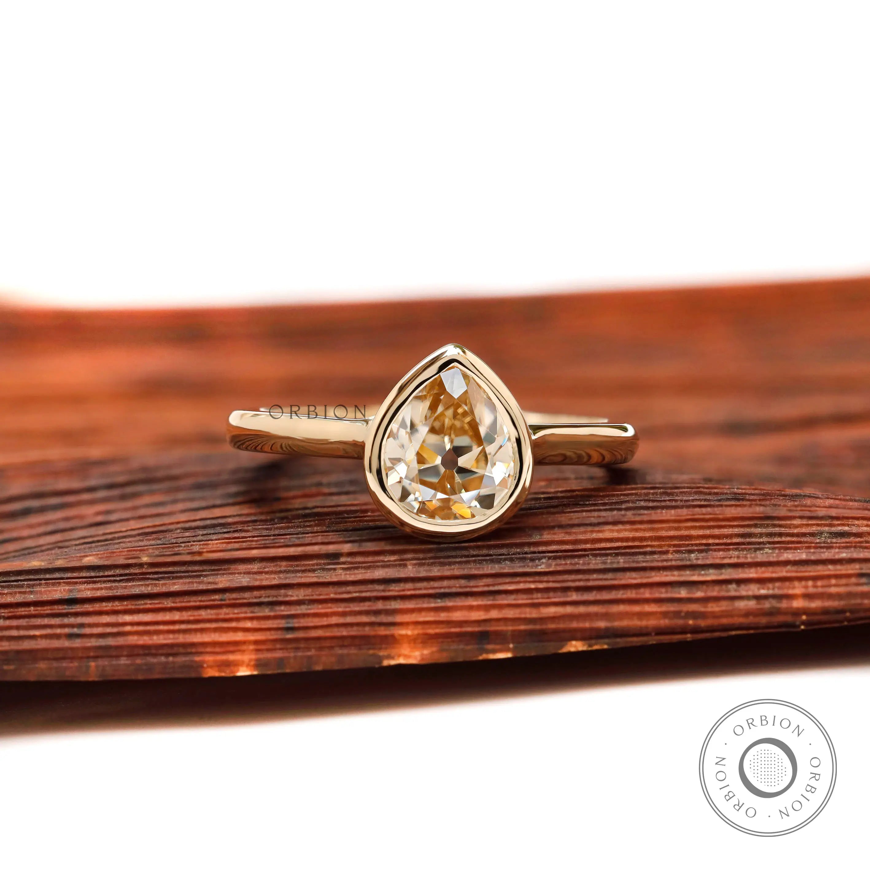 Pear Old Mine Cut light champagne moissanite bezel solitaire ring