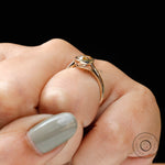 Elegant pear champagne moissanite ring worn on hand