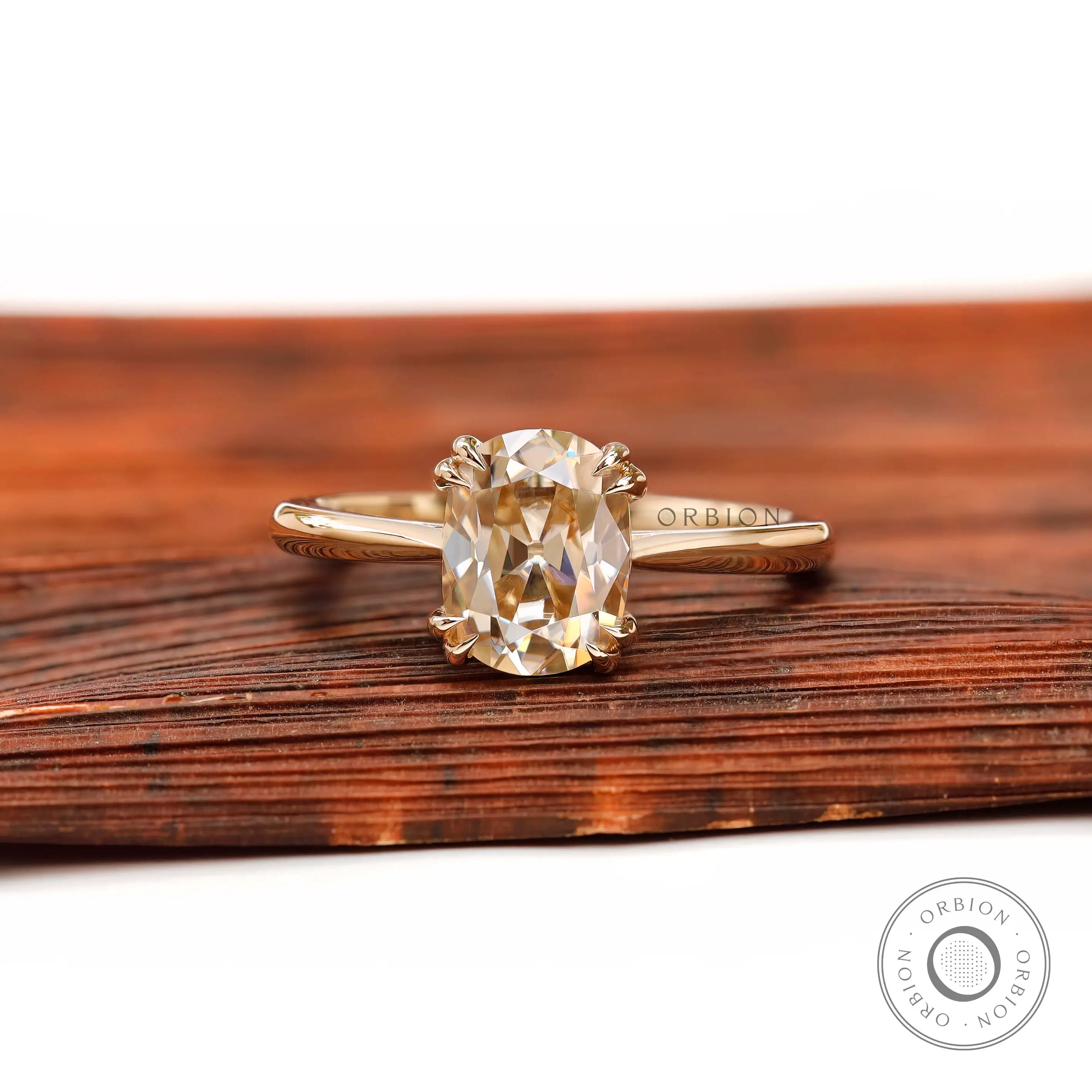 Front view of elongated cushion champagne moissanite cathedral solitaire ring