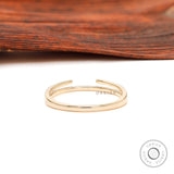 Back view of minimalist open cuff yellow gold band