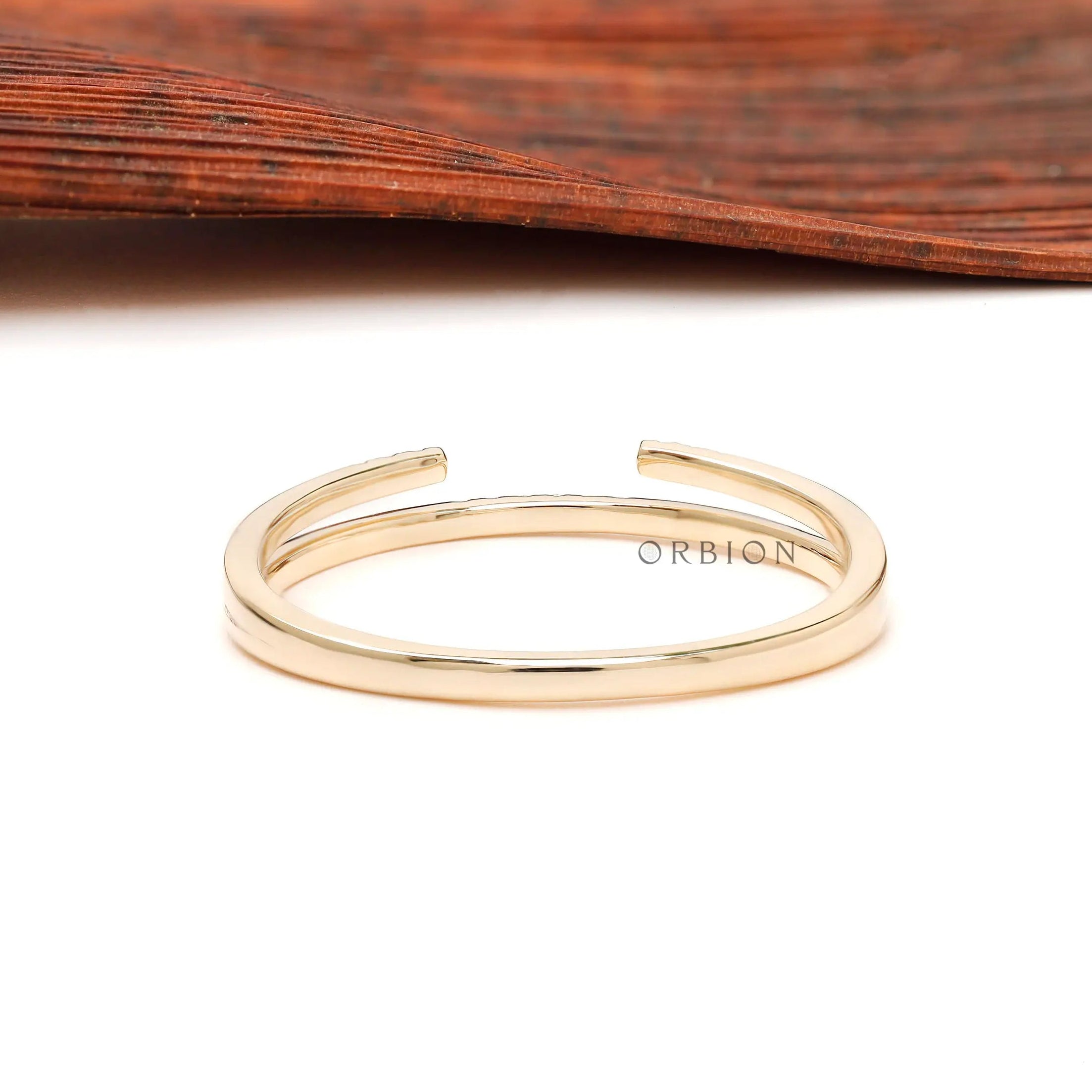 Back view of minimalist open cuff yellow gold band