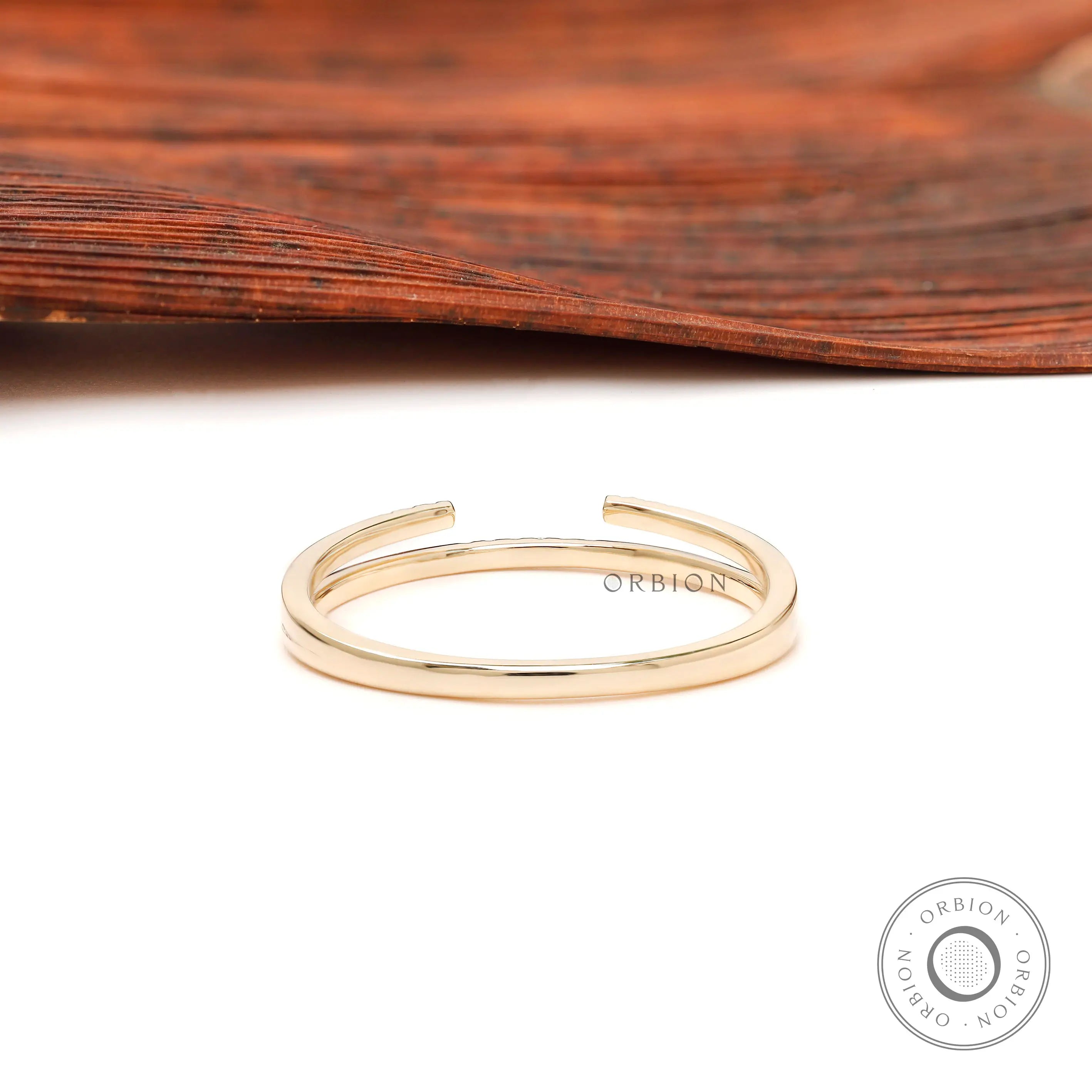 Back view of minimalist open cuff yellow gold band