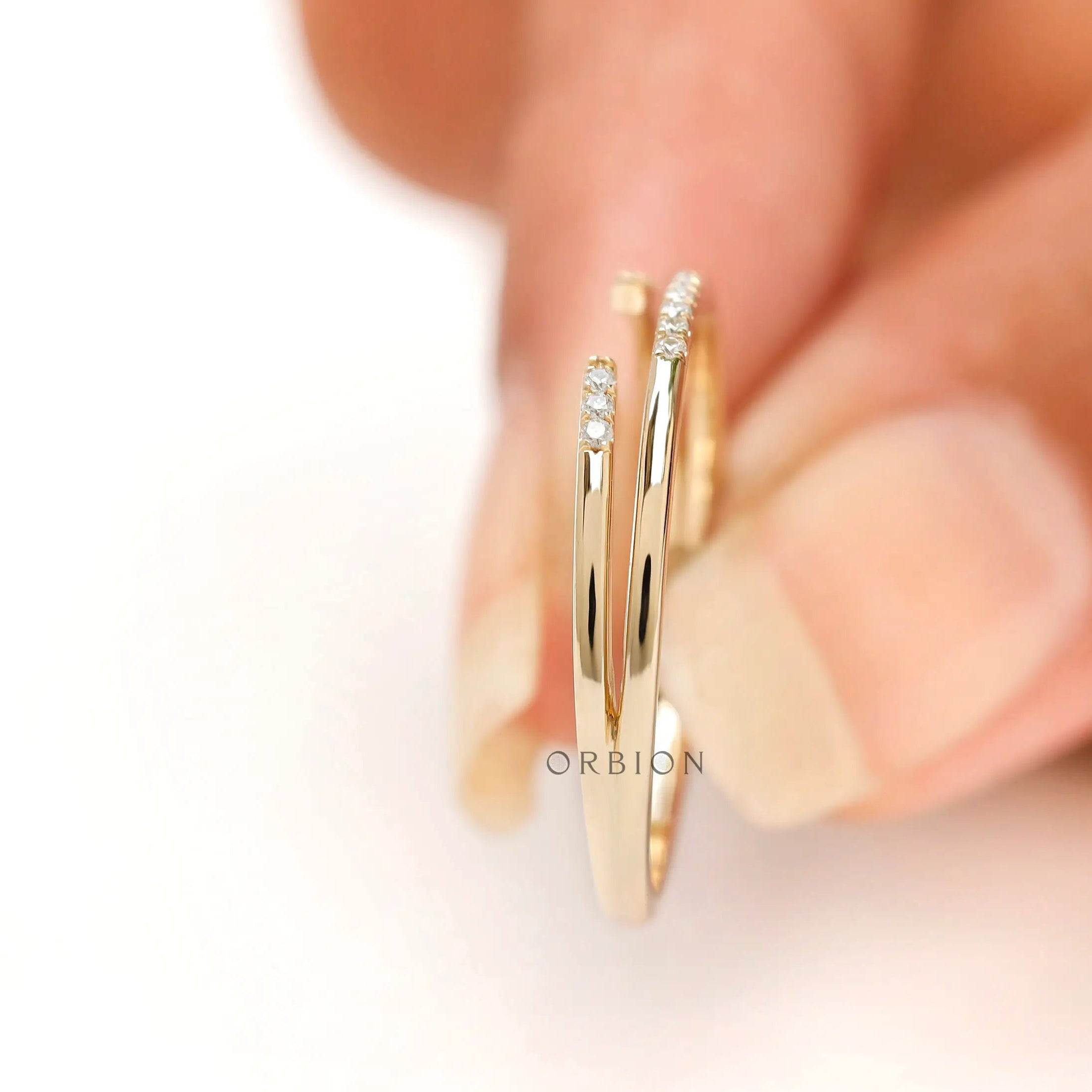 Close up of pave open cuff ring tips held on finger