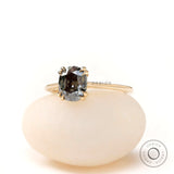 Yellow gold solitaire ring with dark grey moissanite close up