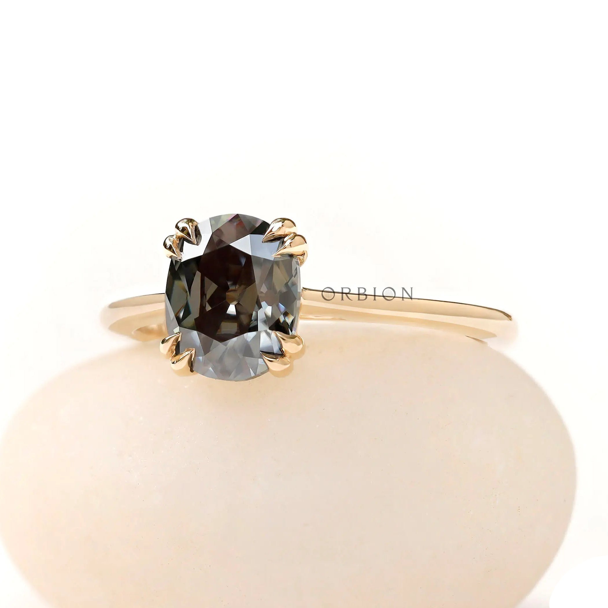 Yellow gold solitaire ring with dark grey moissanite close up