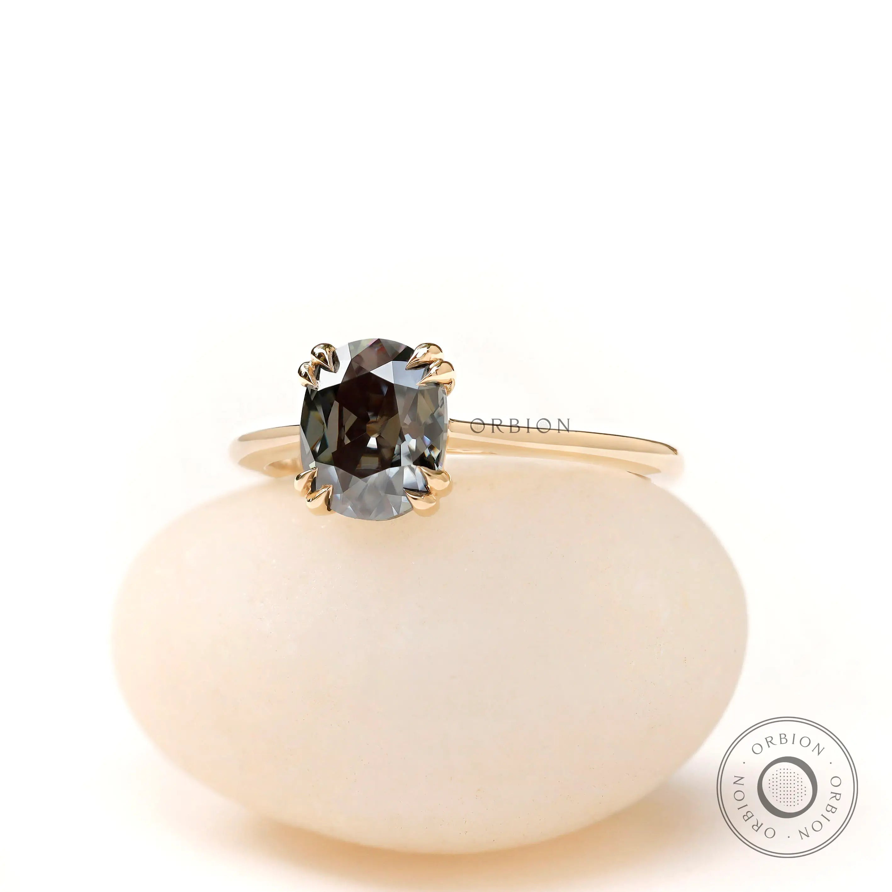 Yellow gold solitaire ring with dark grey moissanite close up