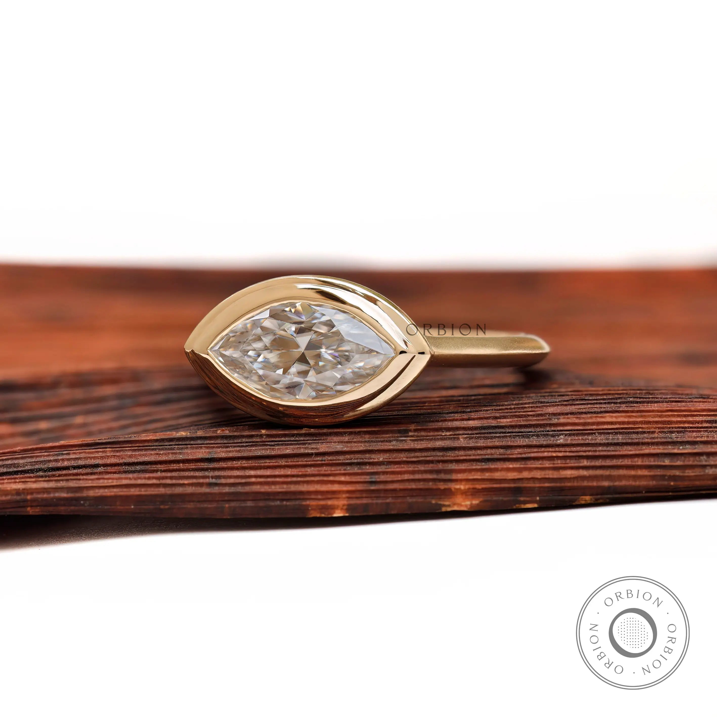 Marquise moissanite bezel ring dual finish gold