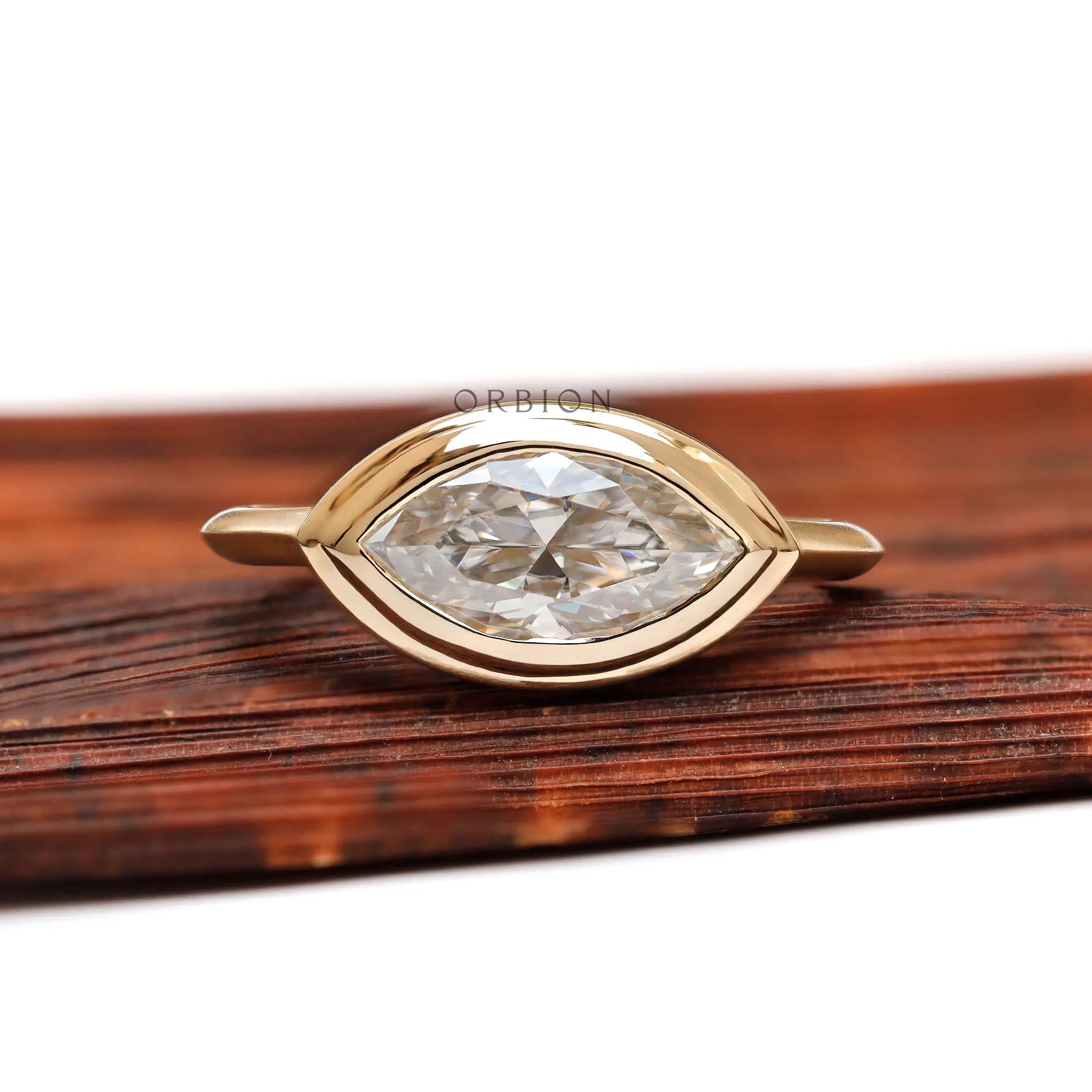 East west marquise bezel engagement ring in 14K yellow gold