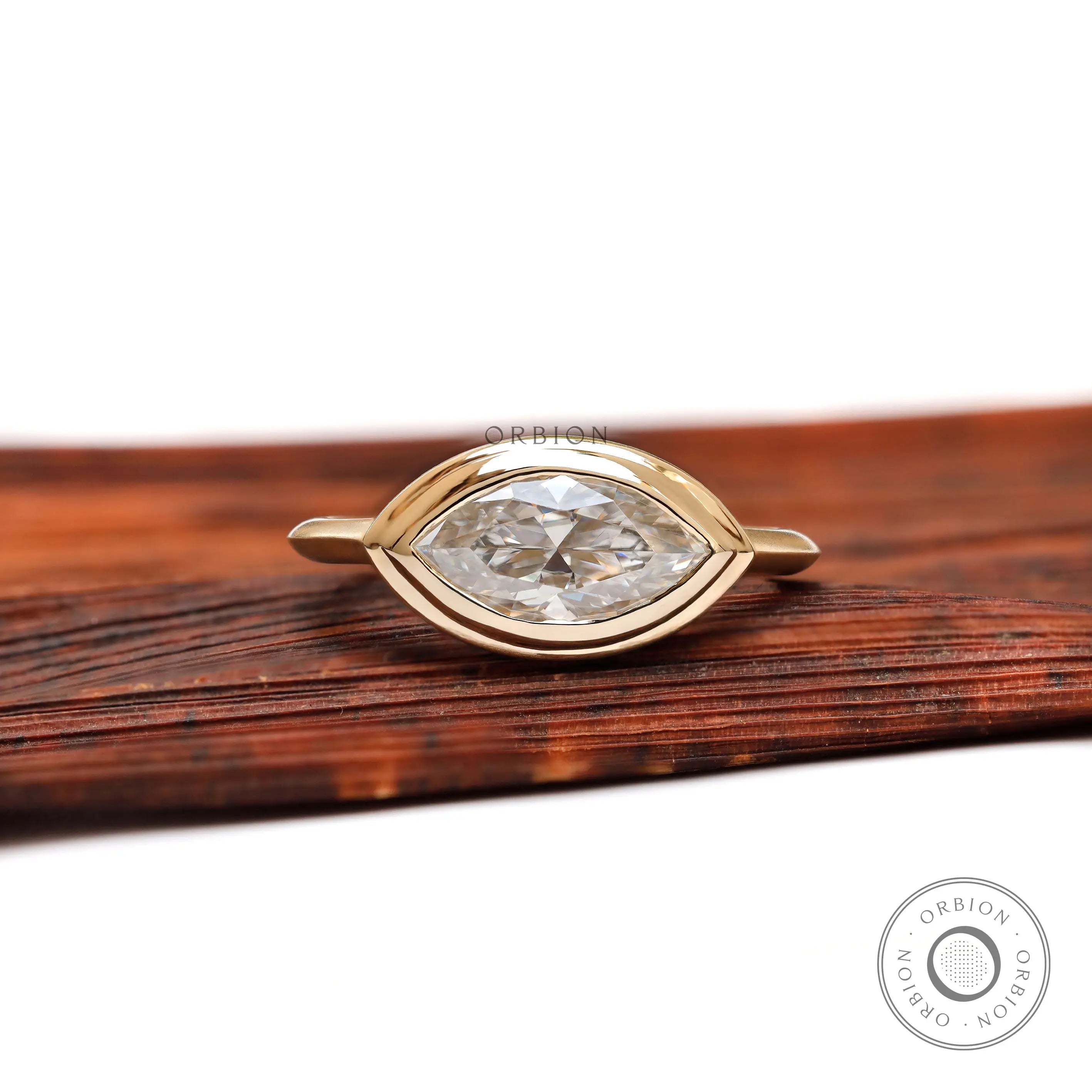 East west marquise bezel engagement ring in 14K yellow gold