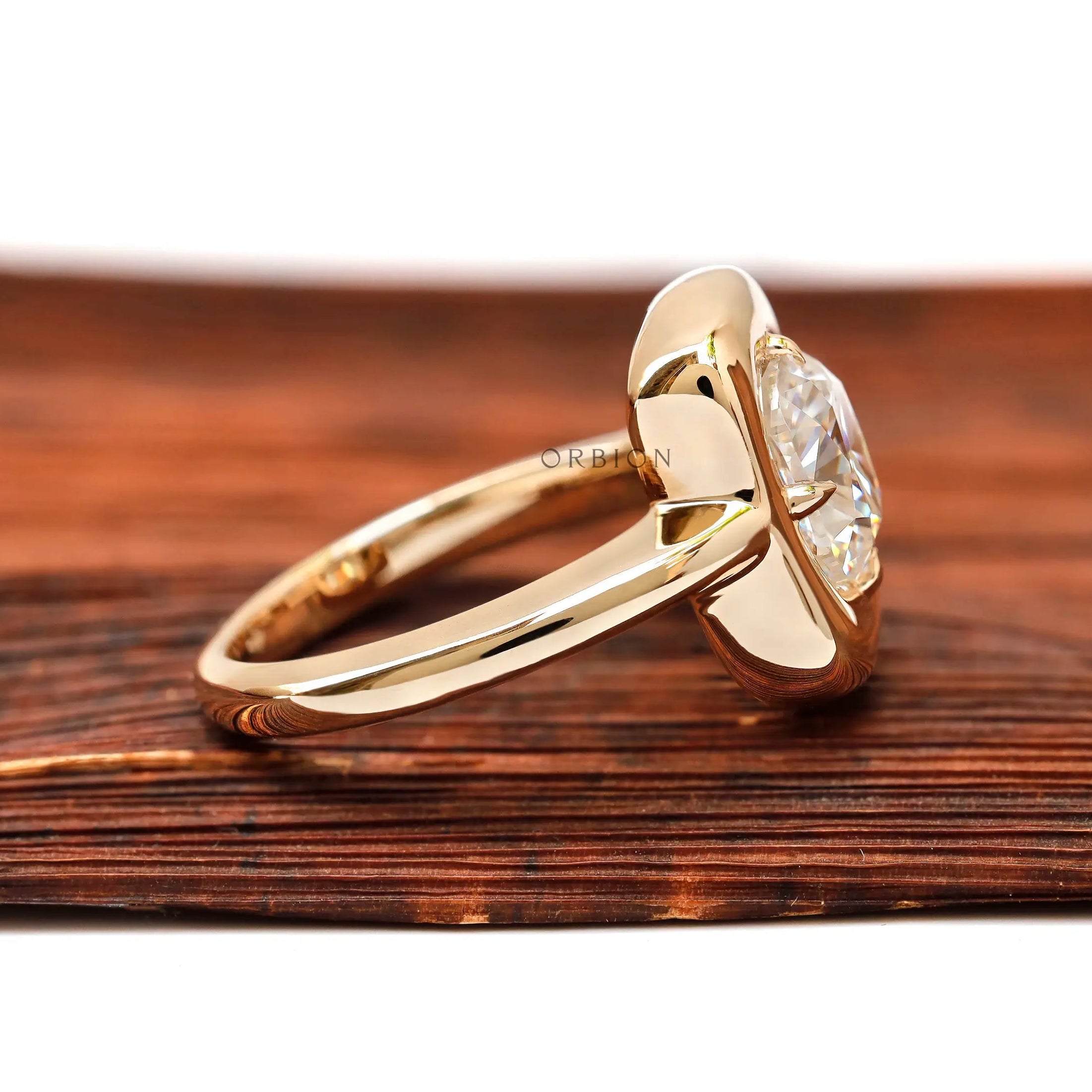 Side profile of cushion moissanite bezel gold ring