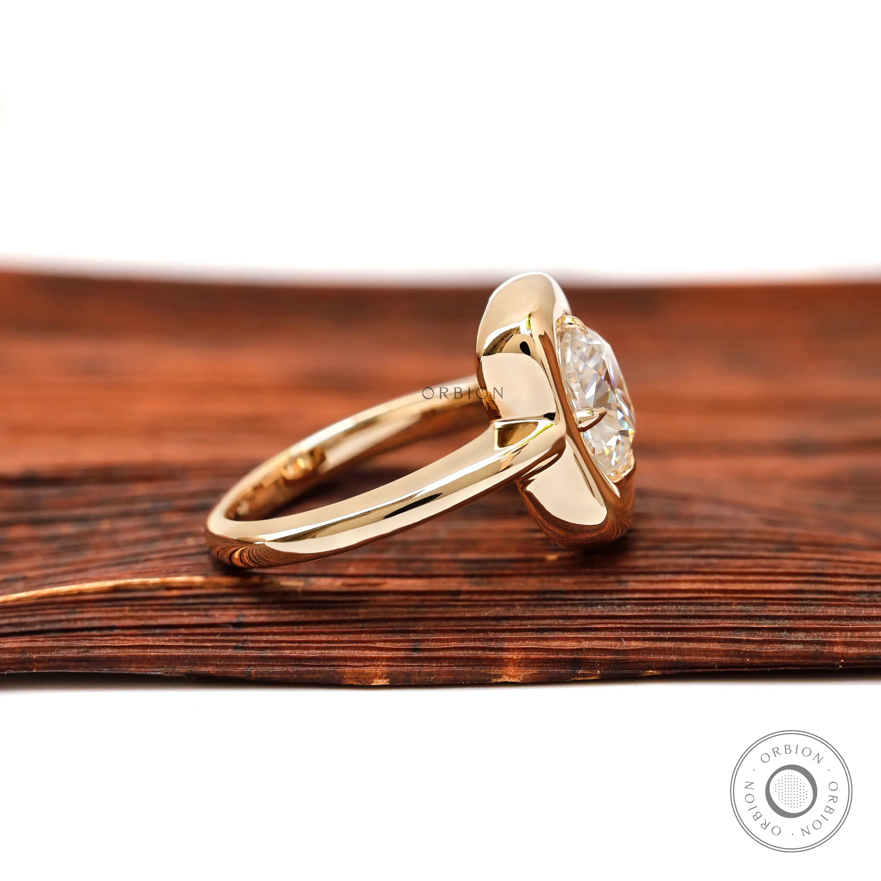 Side profile of cushion moissanite bezel gold ring