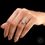 Cushion moissanite bezel ring held in hand