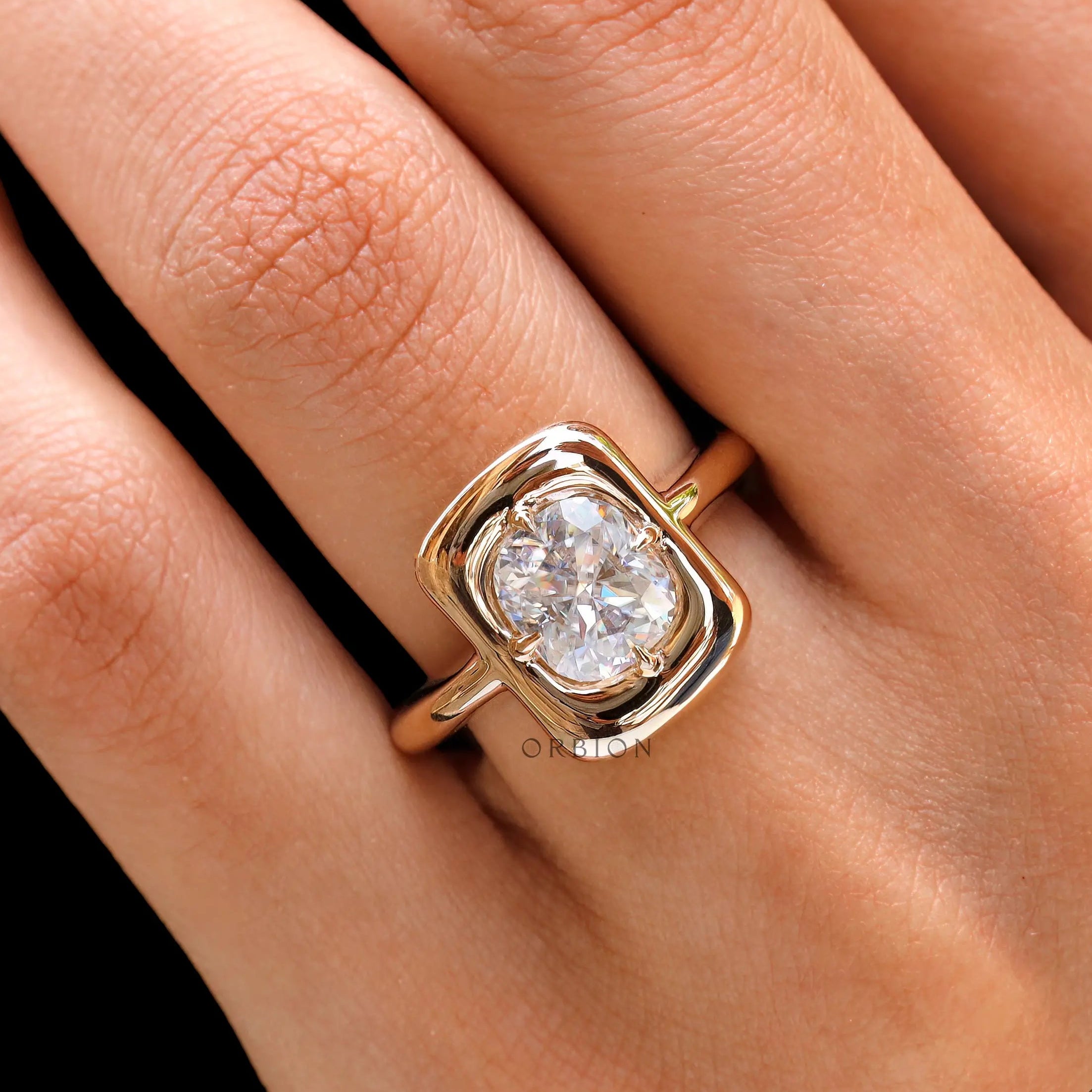 Cushion cut moissanite bezel ring worn on hand