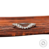Front view of curved bubble prong half eternity diamond wedding band in matte white gold