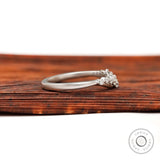 Side profile of matte white gold curved half eternity wedding band