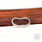 Underside and interior view of curved bubble prong diamond band
