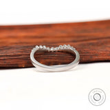 Underside and interior view of curved bubble prong diamond band