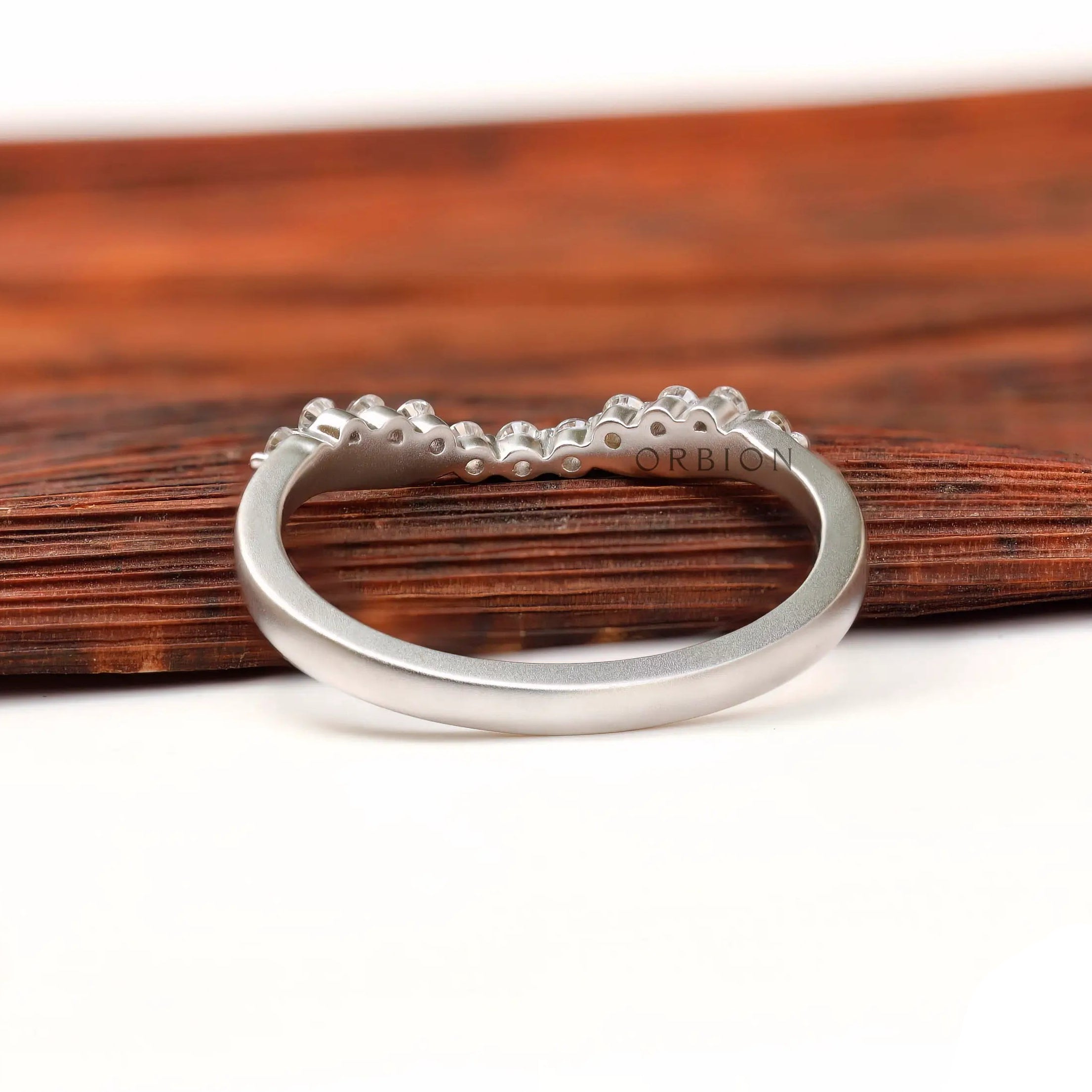 Underside and interior view of curved bubble prong diamond band