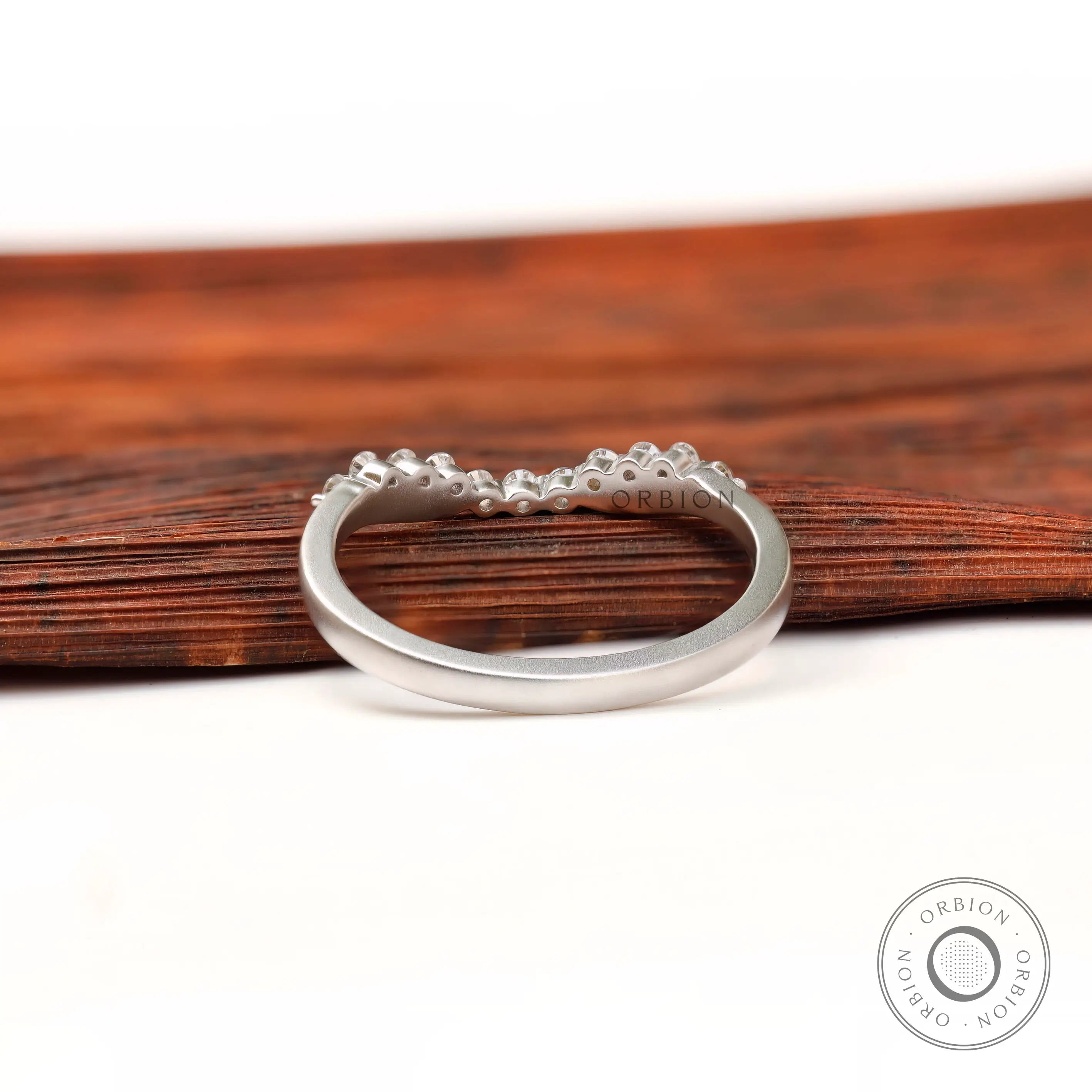Underside and interior view of curved bubble prong diamond band