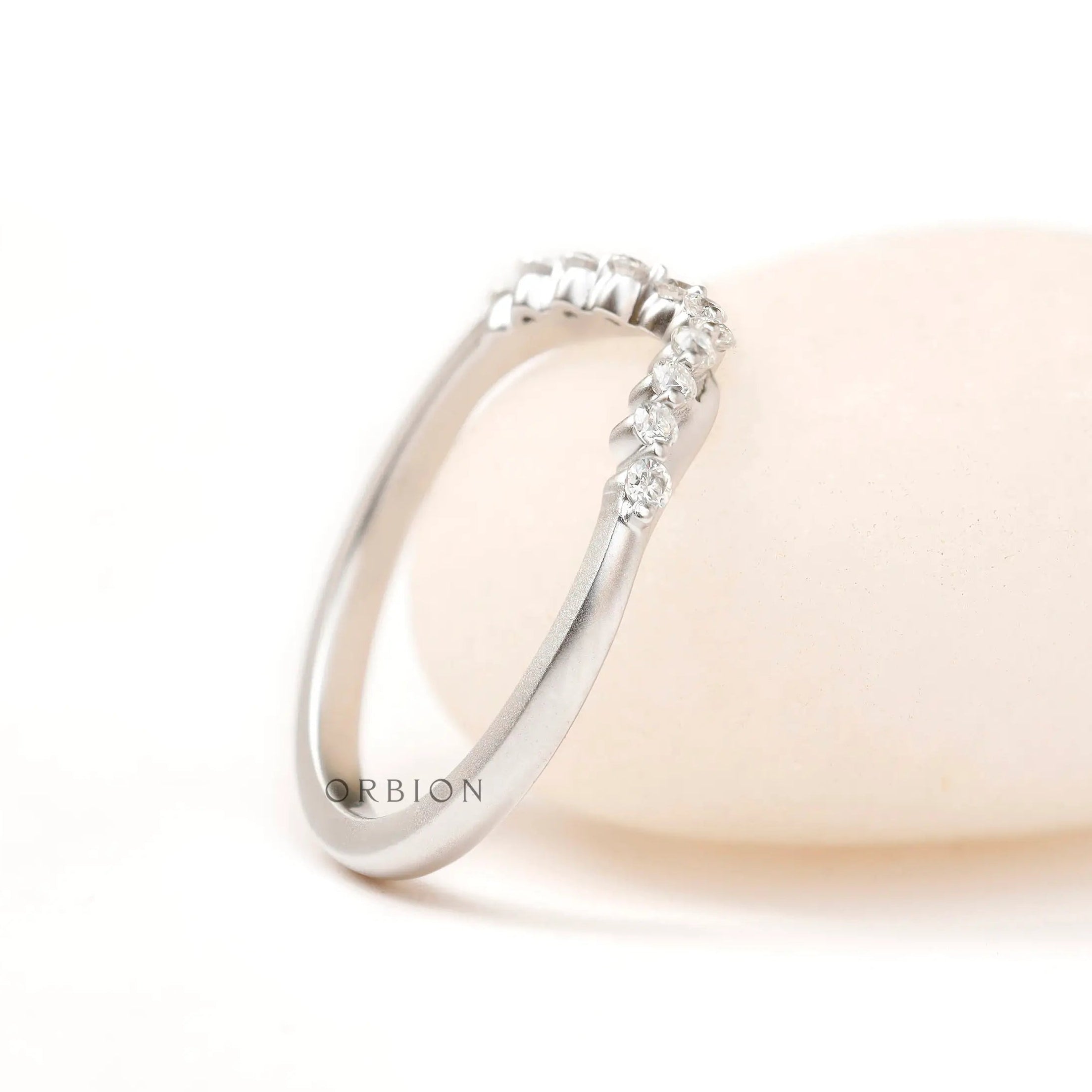 Side angled view highlighting matte white gold finish and diamond curve
