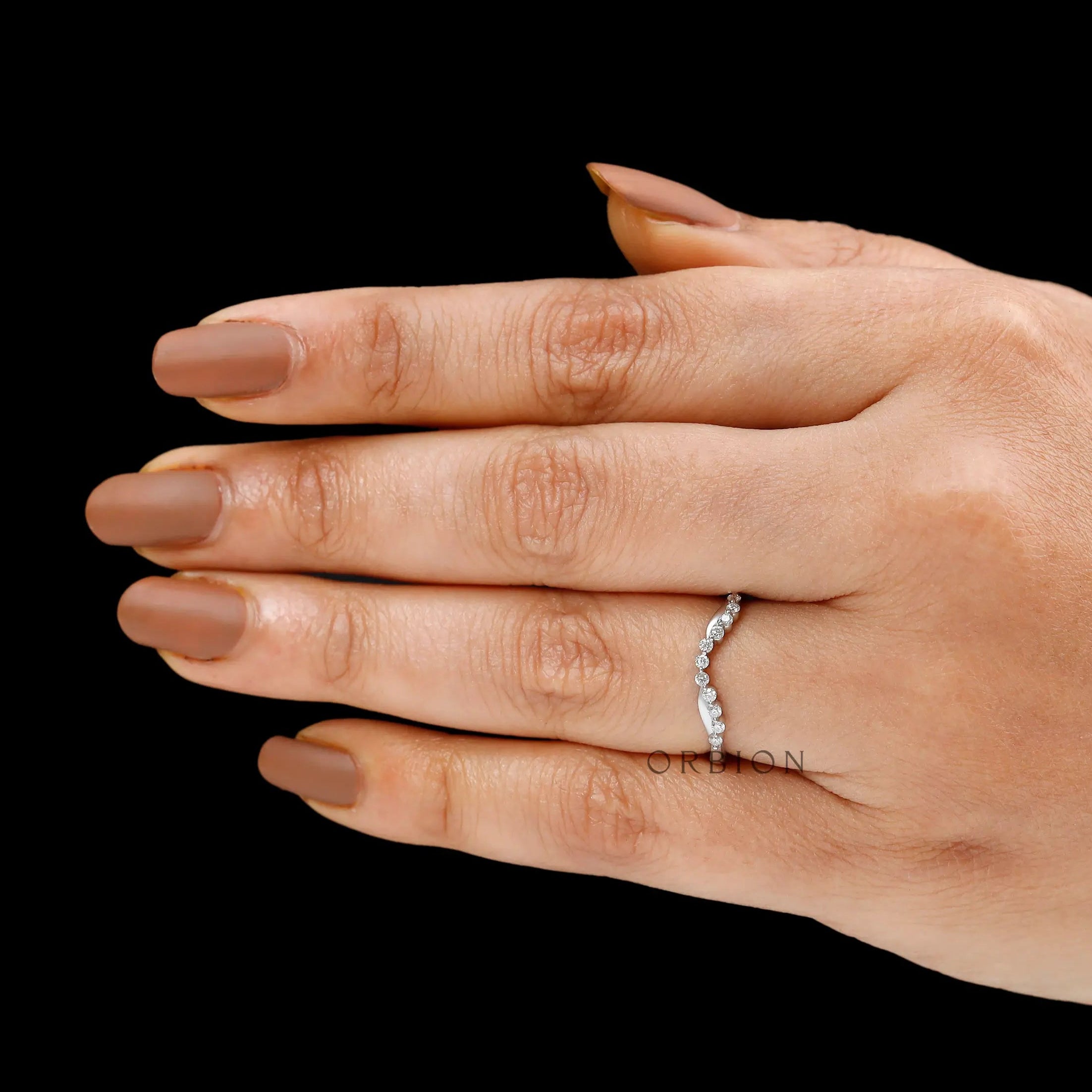 Minimal curved diamond wedding band styled as unique stacking ring