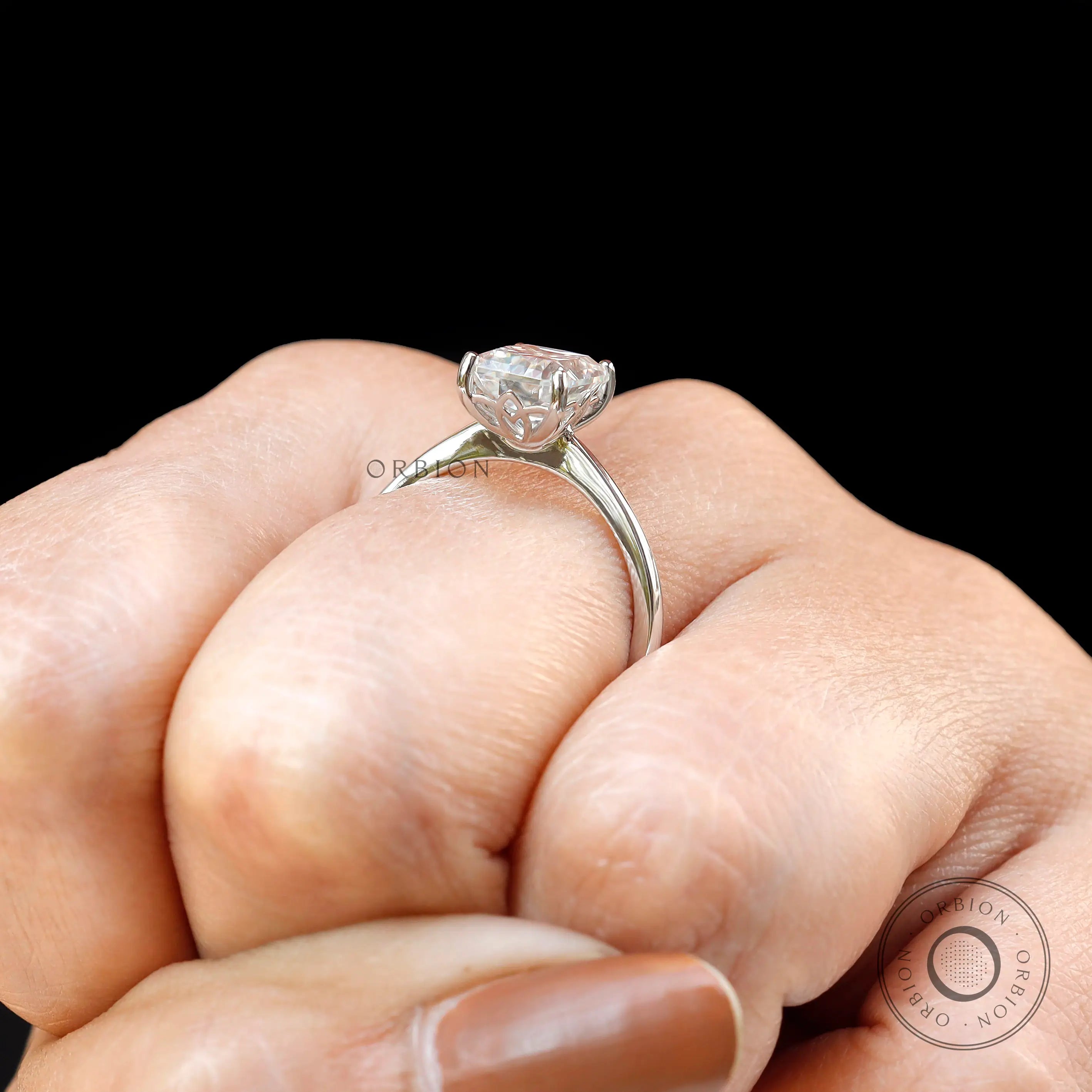 Radiant cut lab diamond solitaire ring on hand in white gold