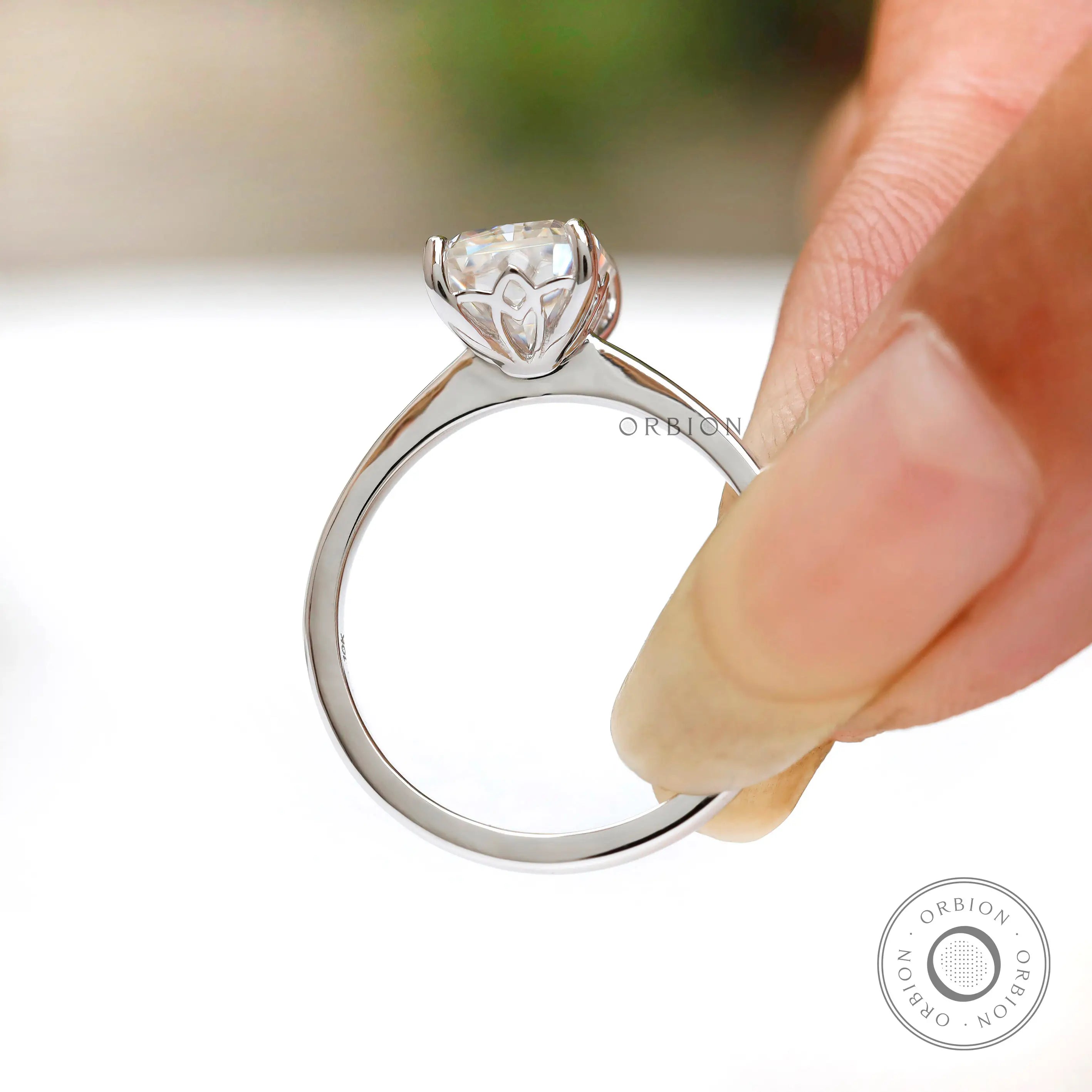 Radiant cut lab diamond solitaire ring in hand in white gold