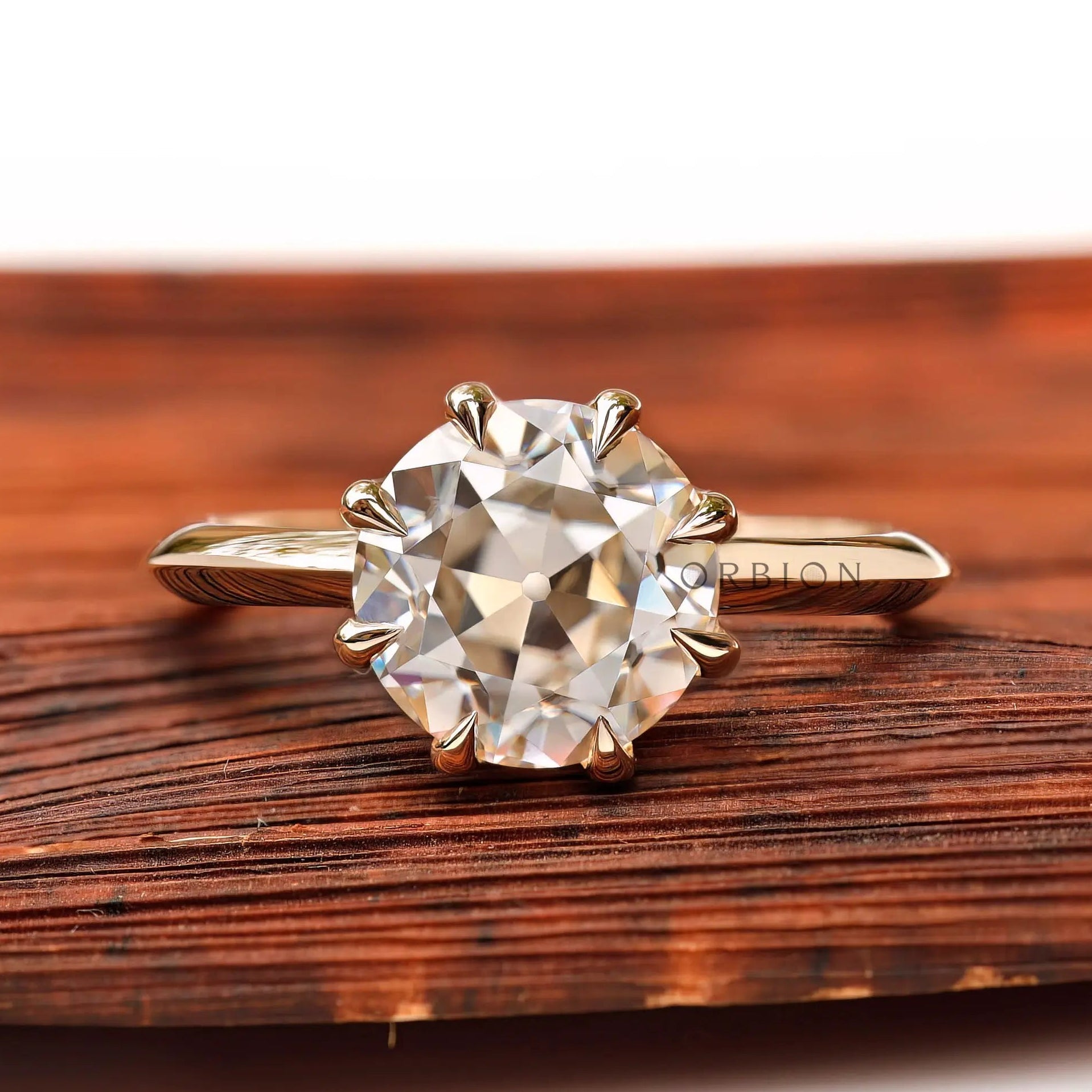Round Old European cut moissanite solitaire ring in yellow gold