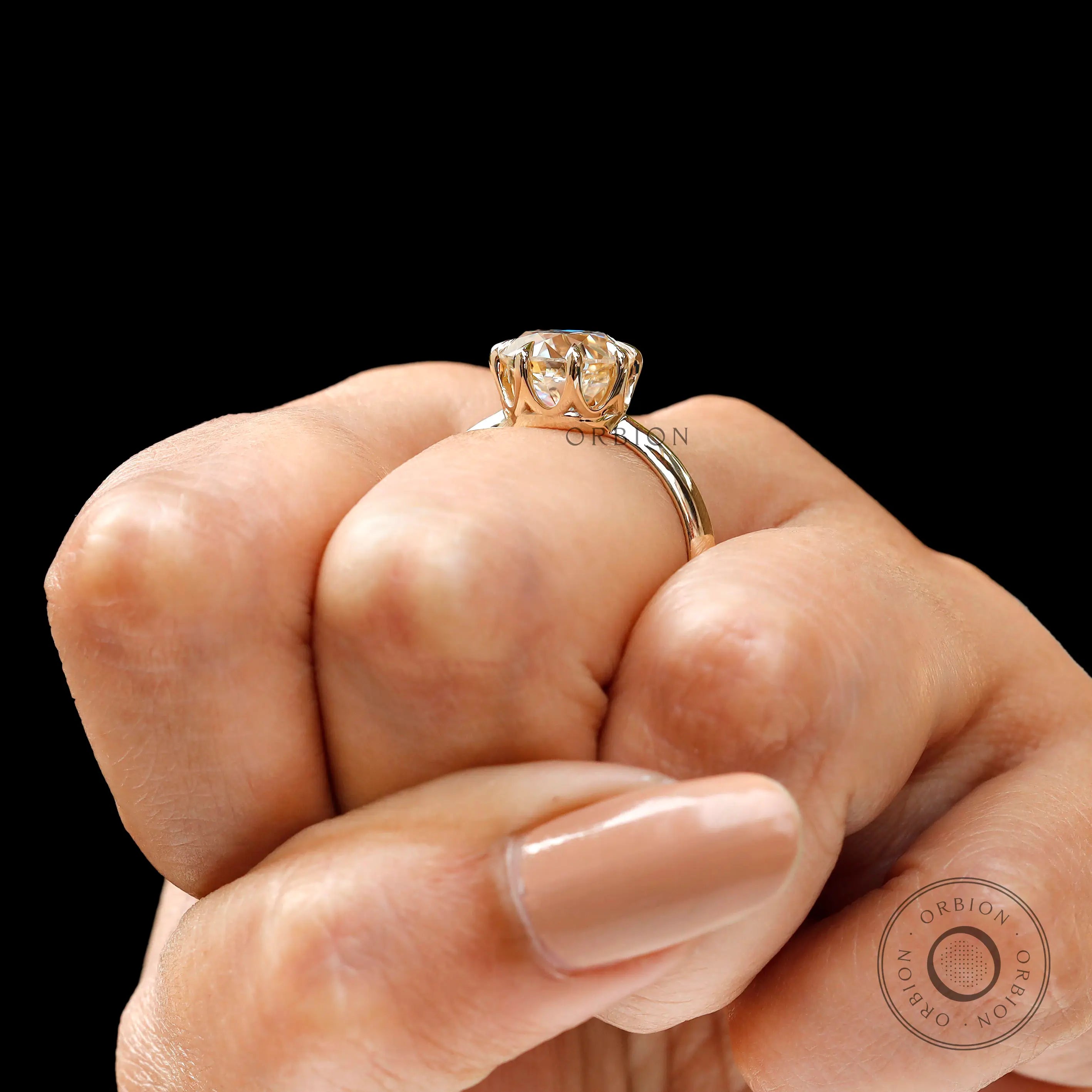 Close up of round moissanite prong setting detail