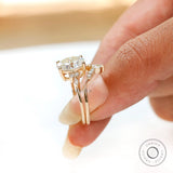Contoured wedding band paired with oval cluster engagement ring