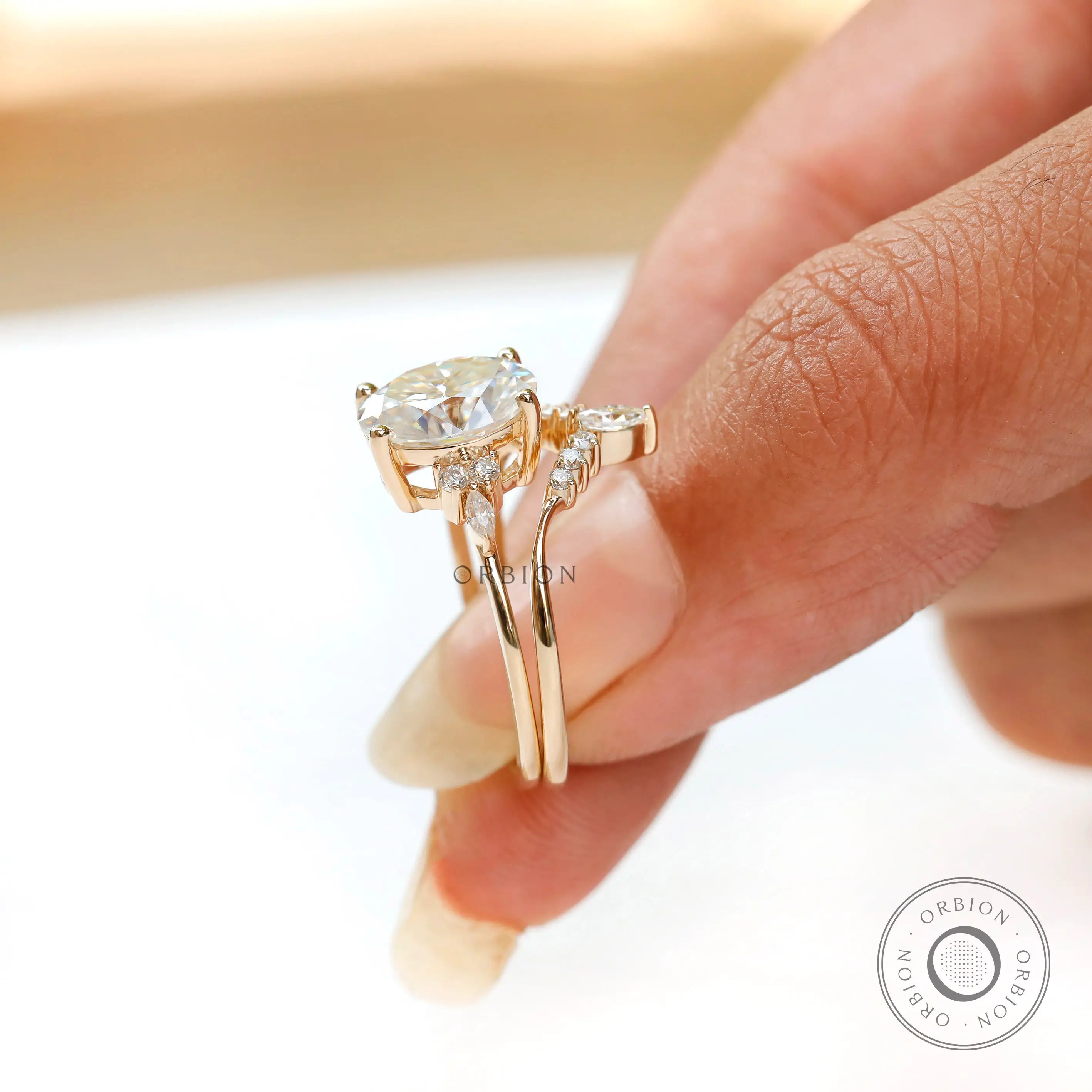 Contoured wedding band paired with oval cluster engagement ring