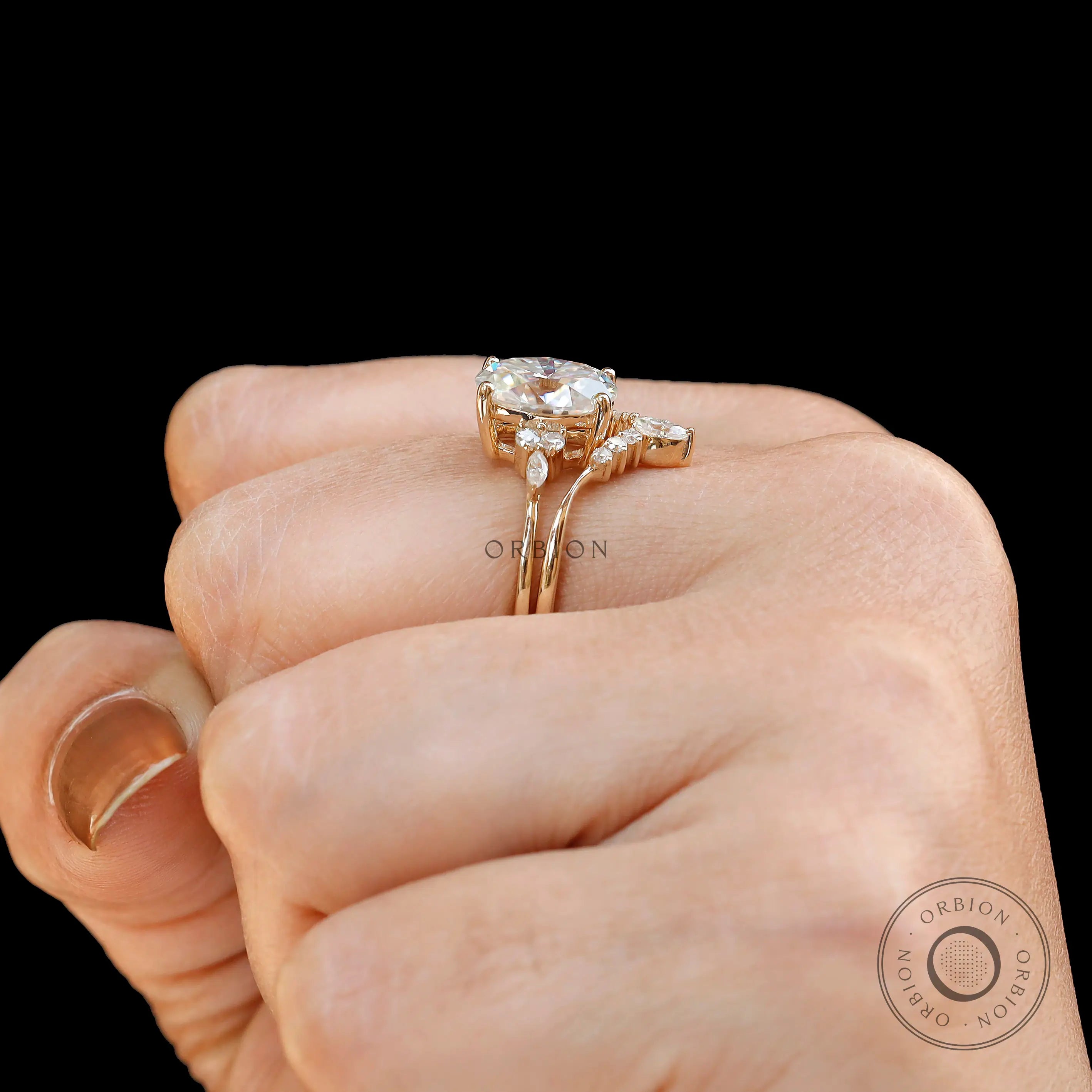 Yellow gold cluster bridal ring set photographed on hand