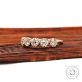 Angled view highlighting five round moissanite stones