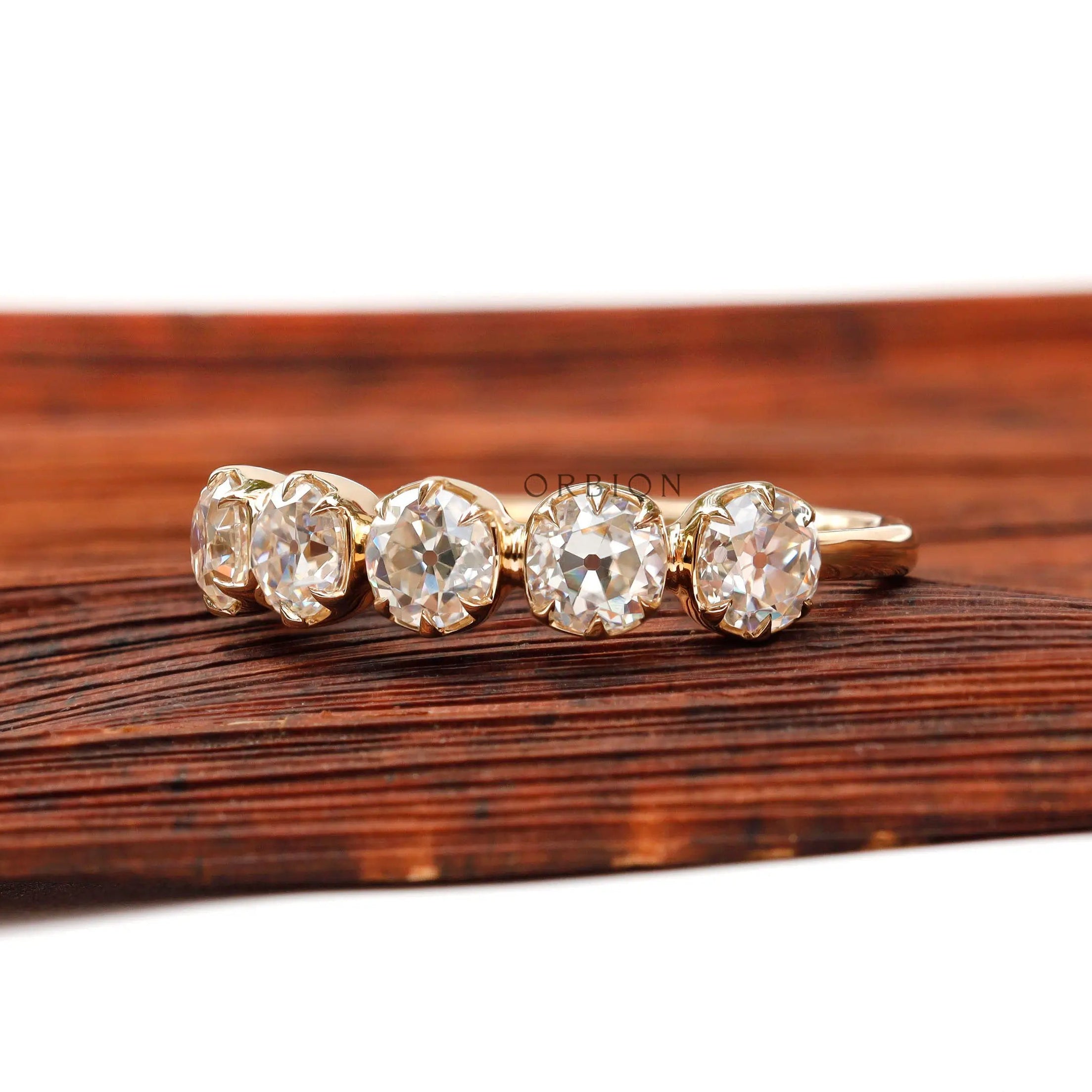 Angled view highlighting five round moissanite stones