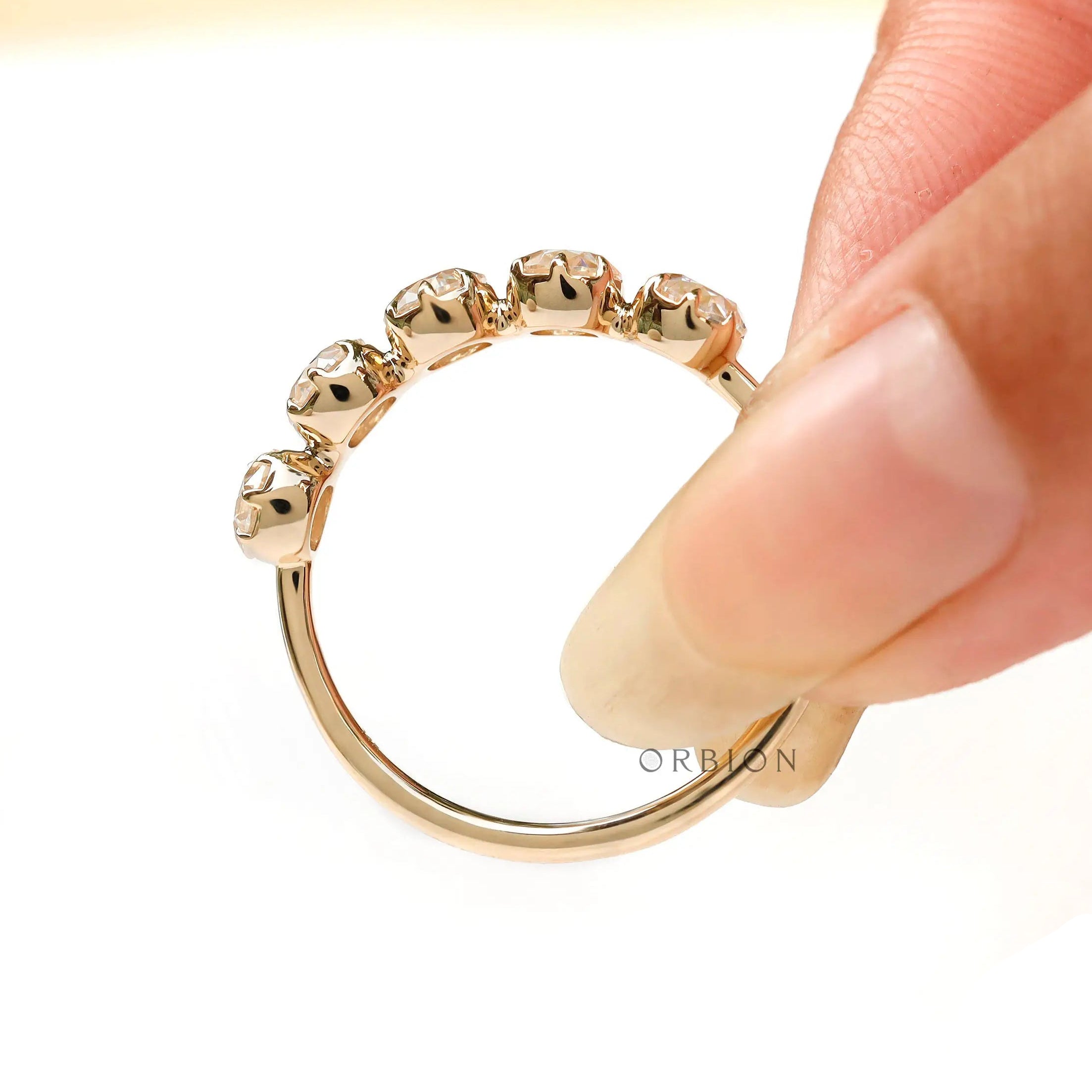 Top view of curved five stone moissanite ring