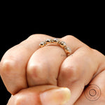 On hand view of five stone moissanite band