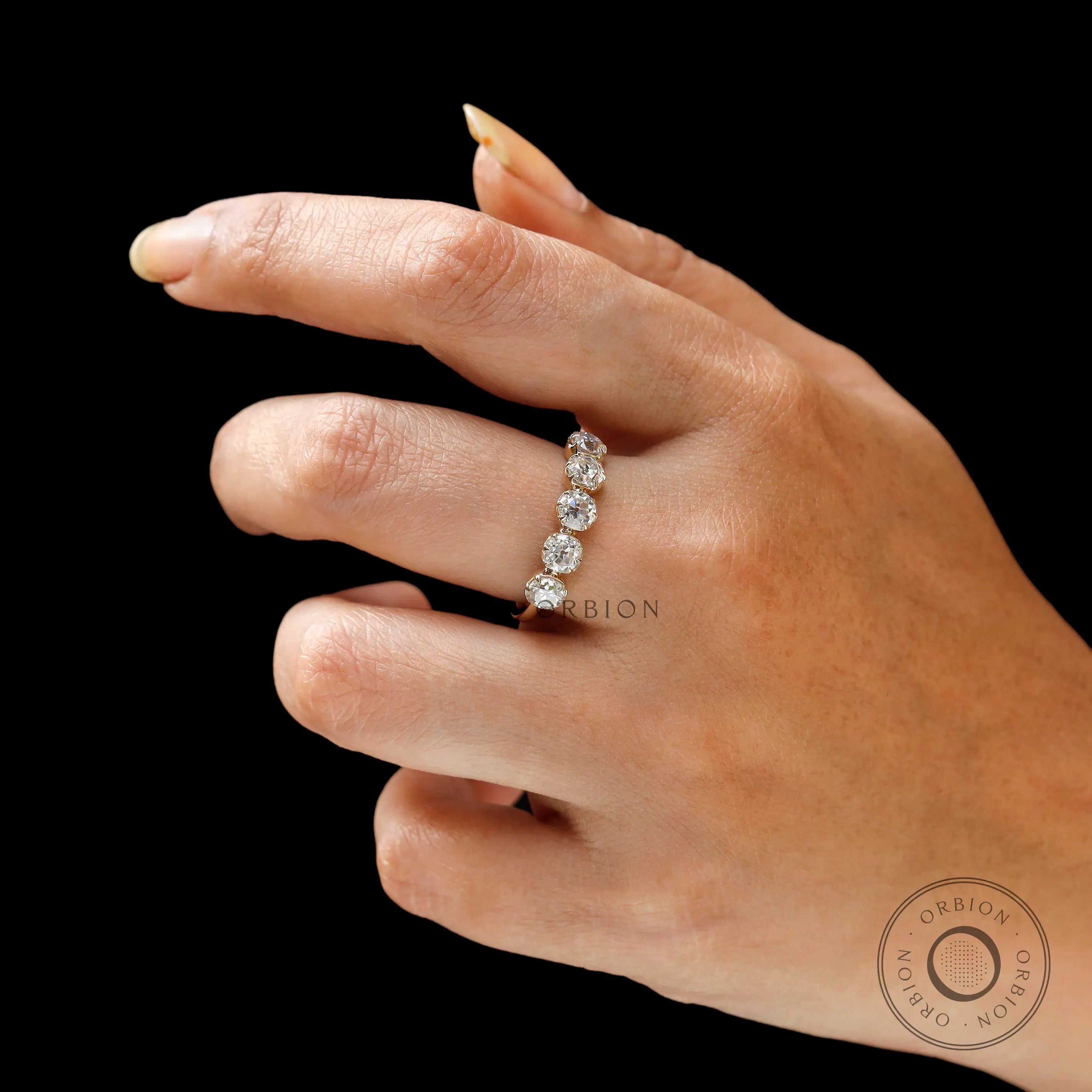 Lifestyle view of five stone yellow gold band