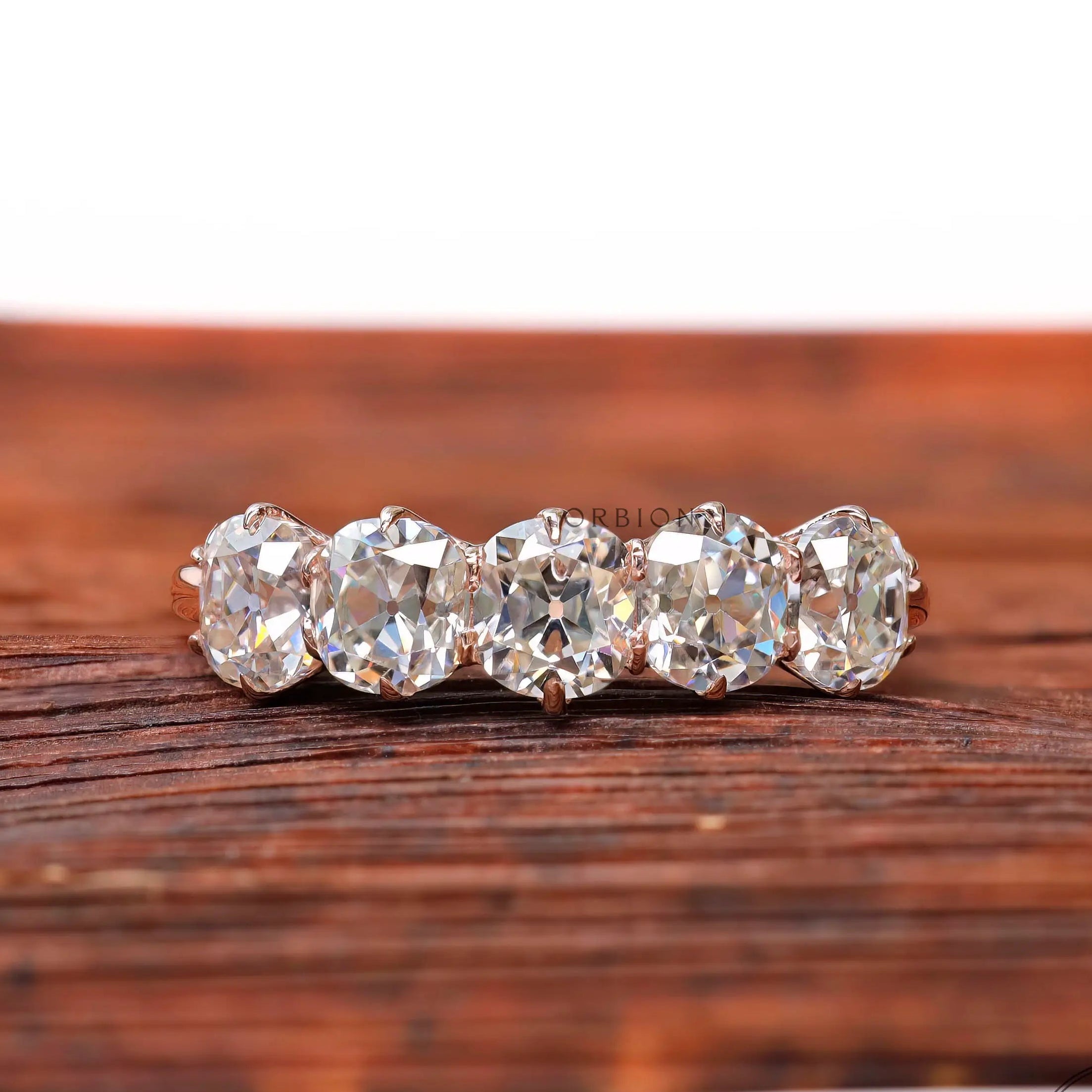 Front view of five elongated cushion moissanite half eternity band