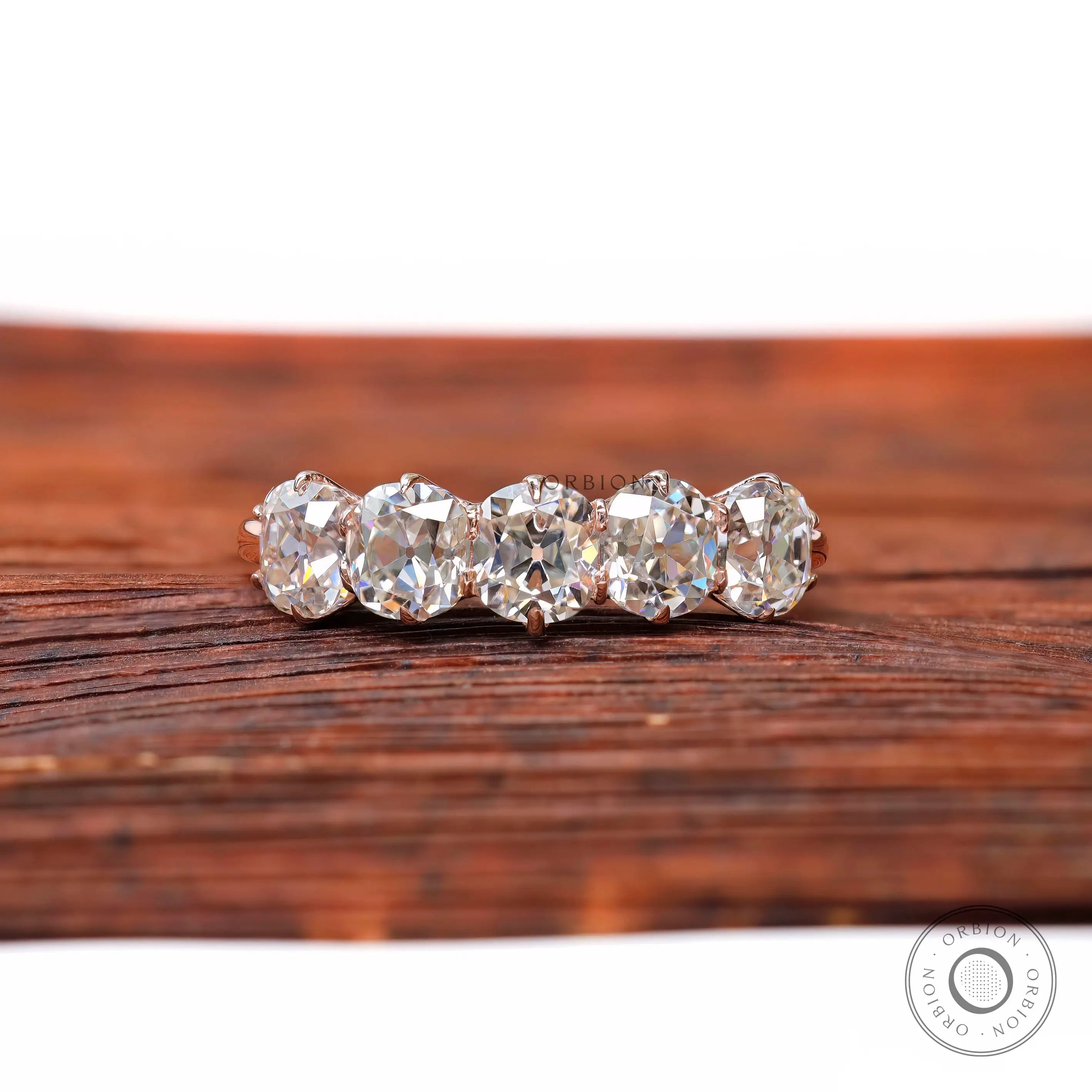 Front view of five elongated cushion moissanite half eternity band
