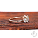Side profile of elongated cushion moissanites in rose gold band