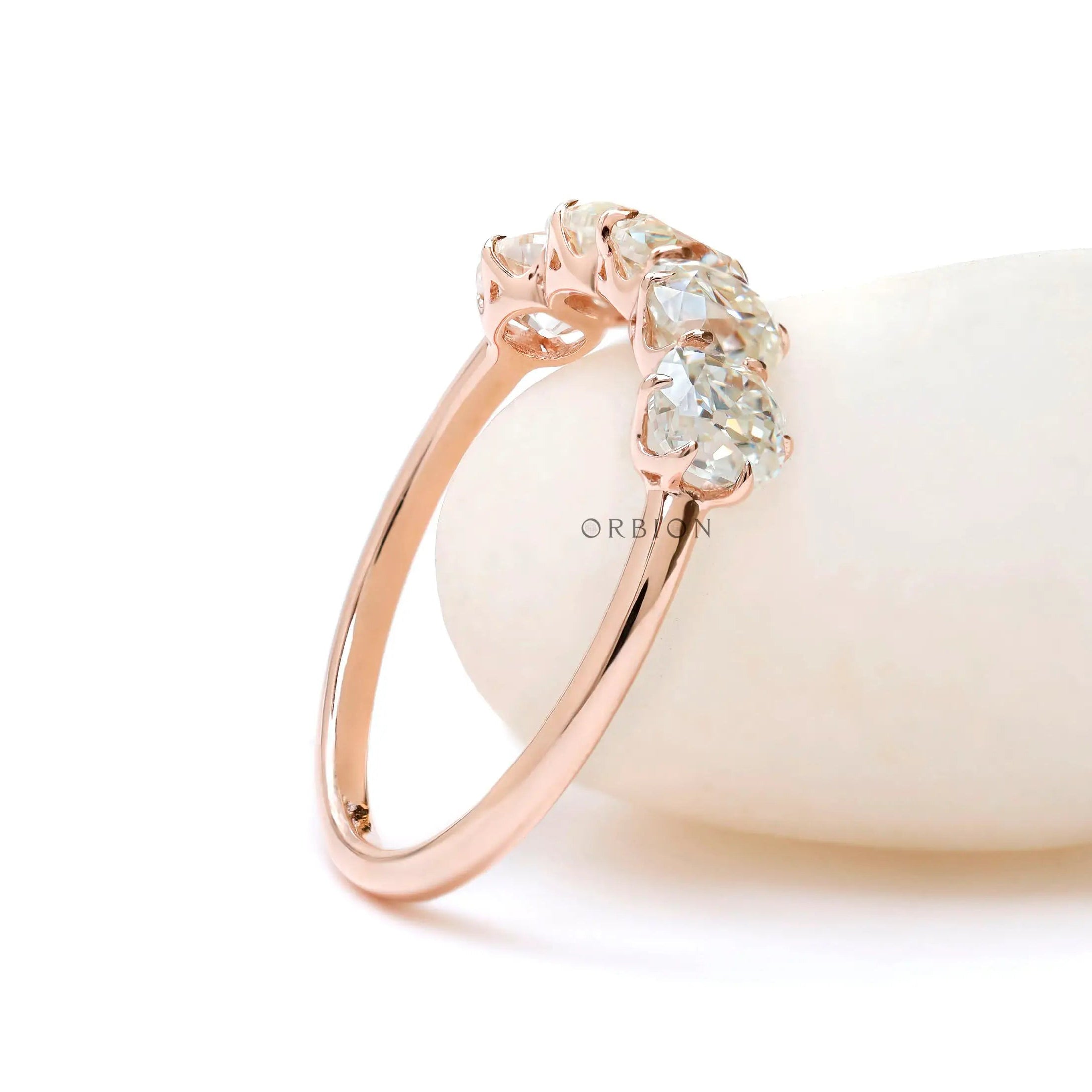 Angled view of elongated cushion moissanites half eternity ring