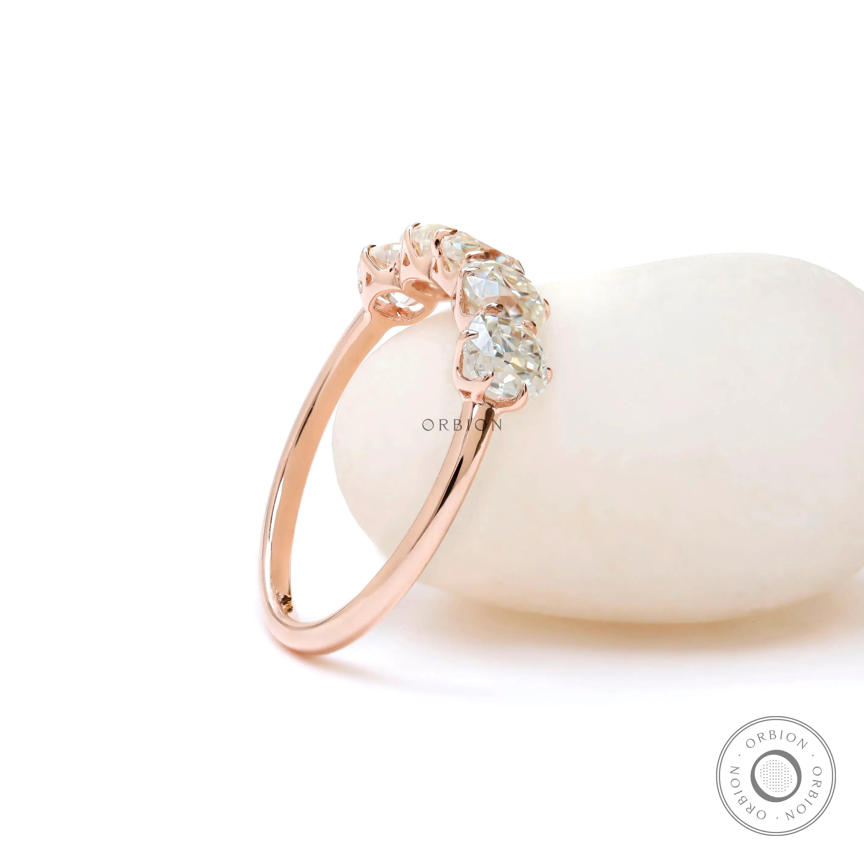 Angled view of elongated cushion moissanites half eternity ring