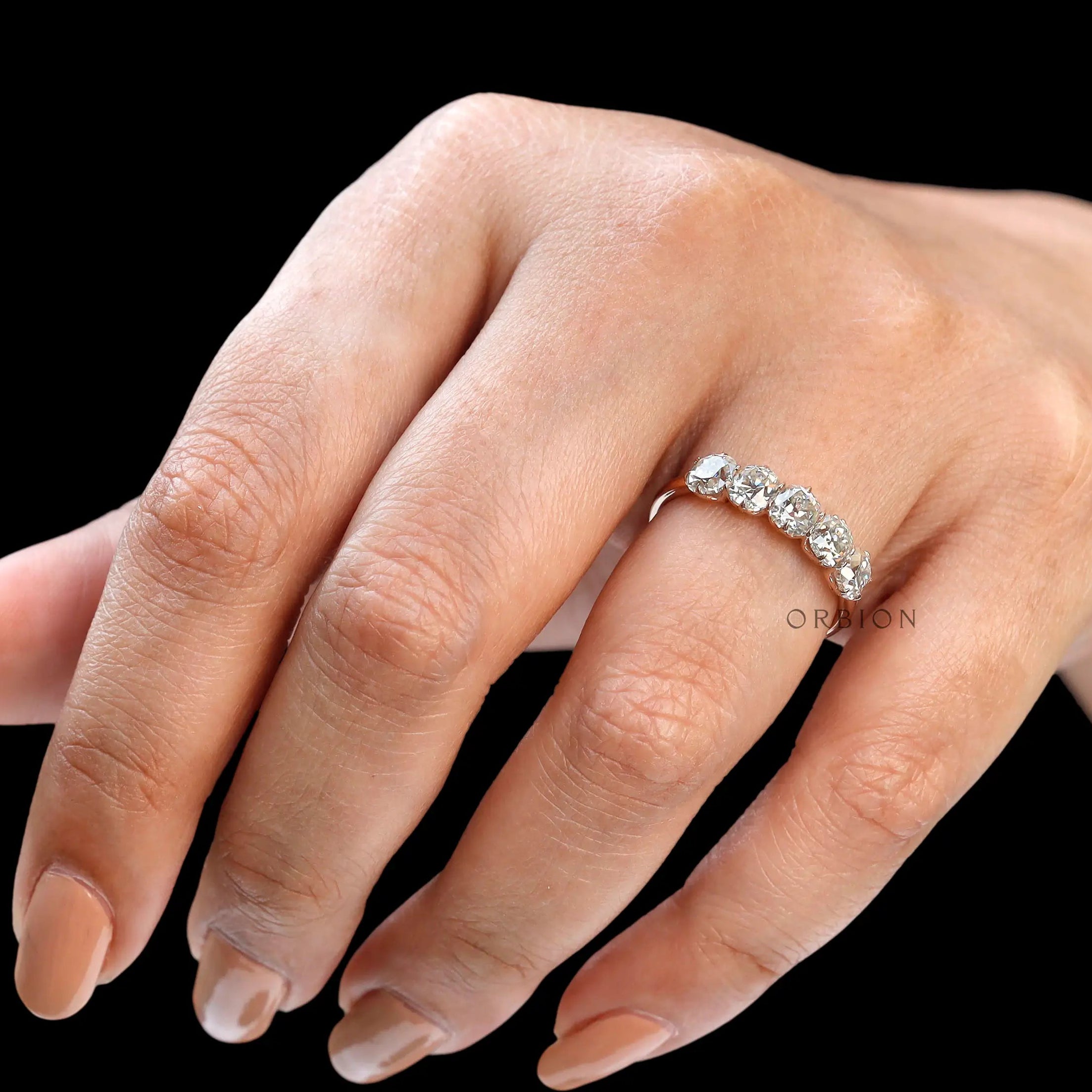 Side hand pose highlighting elongated cushion moissanite band