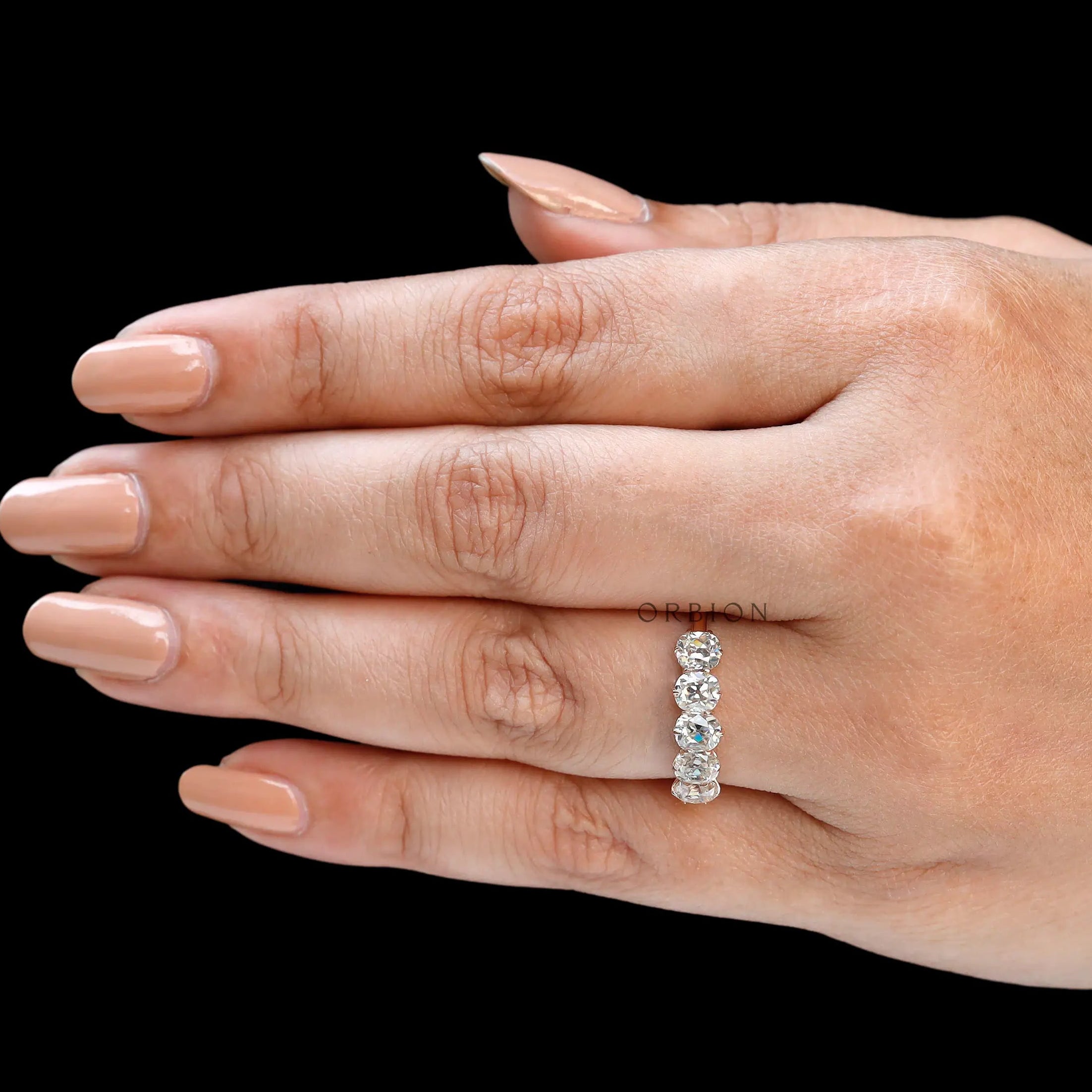 Straight hand view of elongated cushion moissanite half eternity ring