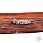 Top view of five-stone moissanite band with asscher center and round accents.