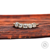 Top view of five-stone moissanite band with asscher center and round accents.