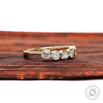 Angled top view showing bezel-set alternating Asscher and round stones.
