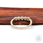 Back view highlighting smooth gallery and polished yellow gold shank.